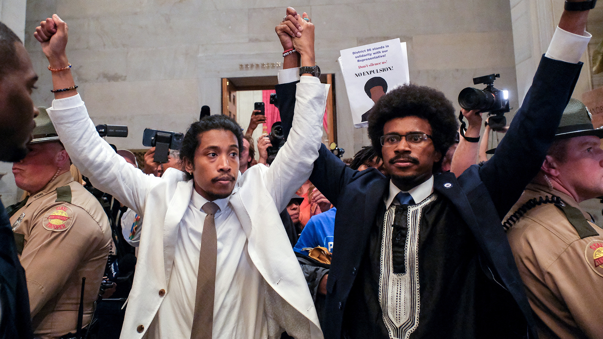 Justin Pearson and Justin Jones raise their hands after being expelled from their seats in Nashville.