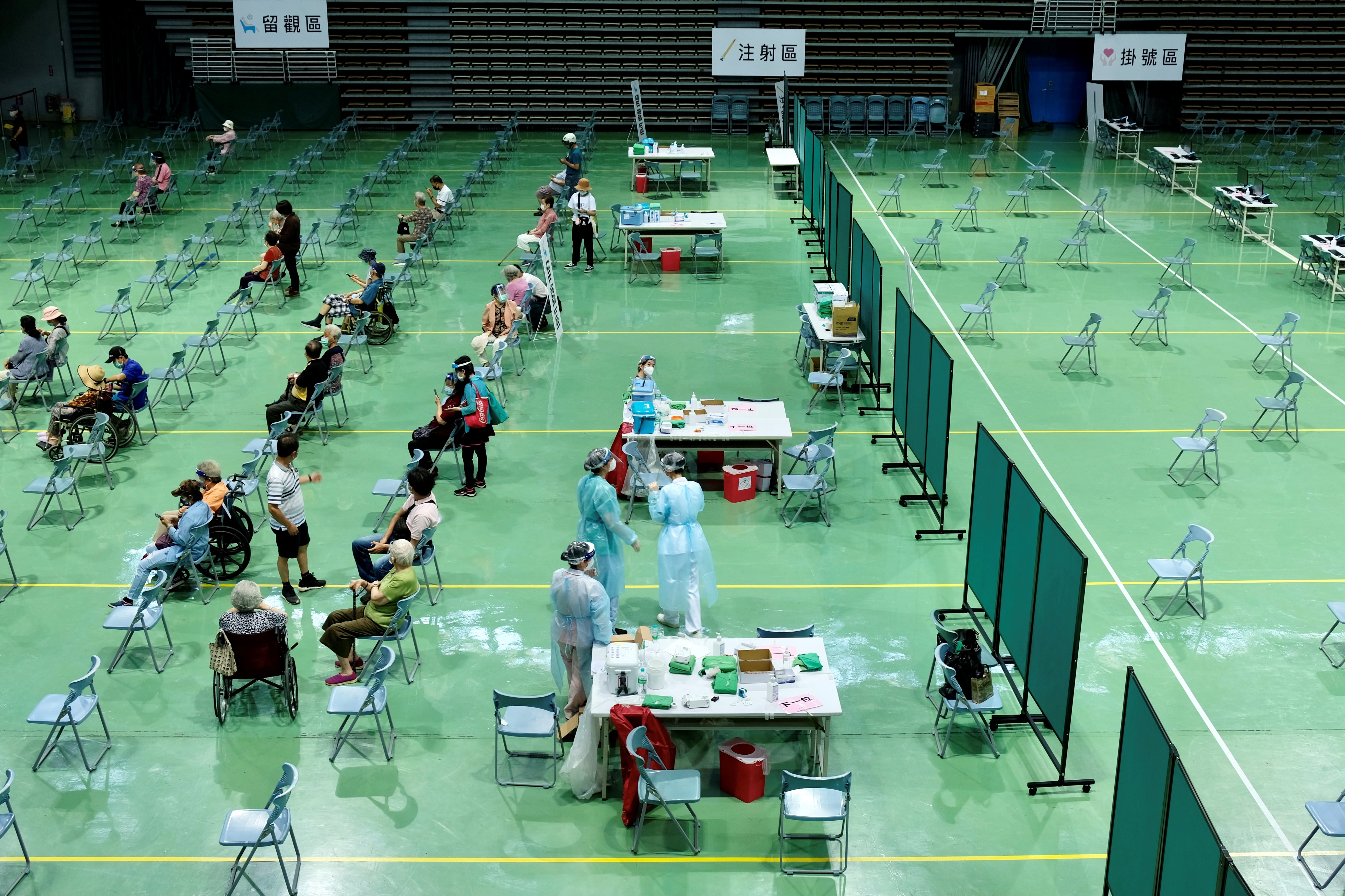 Elderly people await to be vaccinated against Covid-19 coronavirus at the Hsinchuang Stadium in New Taipei City on June 15, 2021. 