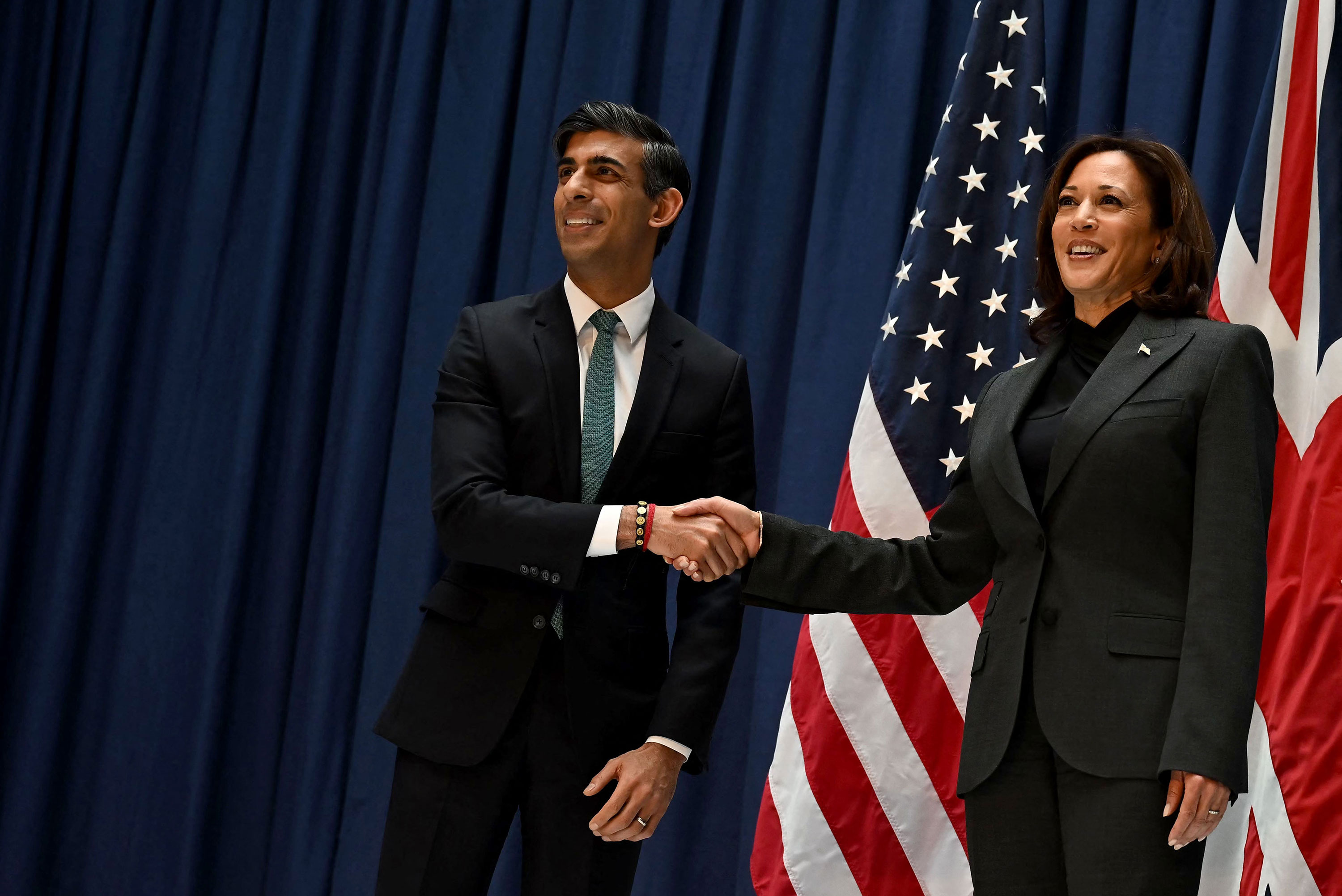 British Prime Minister Rishi Sunak, left, and US Vice President Kamala Harris shake hands as they meet at the Munich Security Conference on February 18. 
