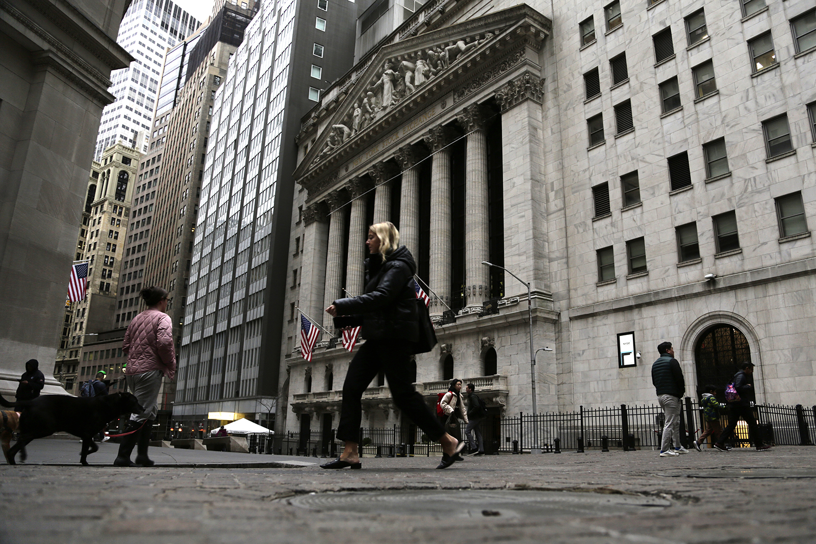 People pass the front of the New York Stock Exchange in New York, on Wednesday, March 22.
