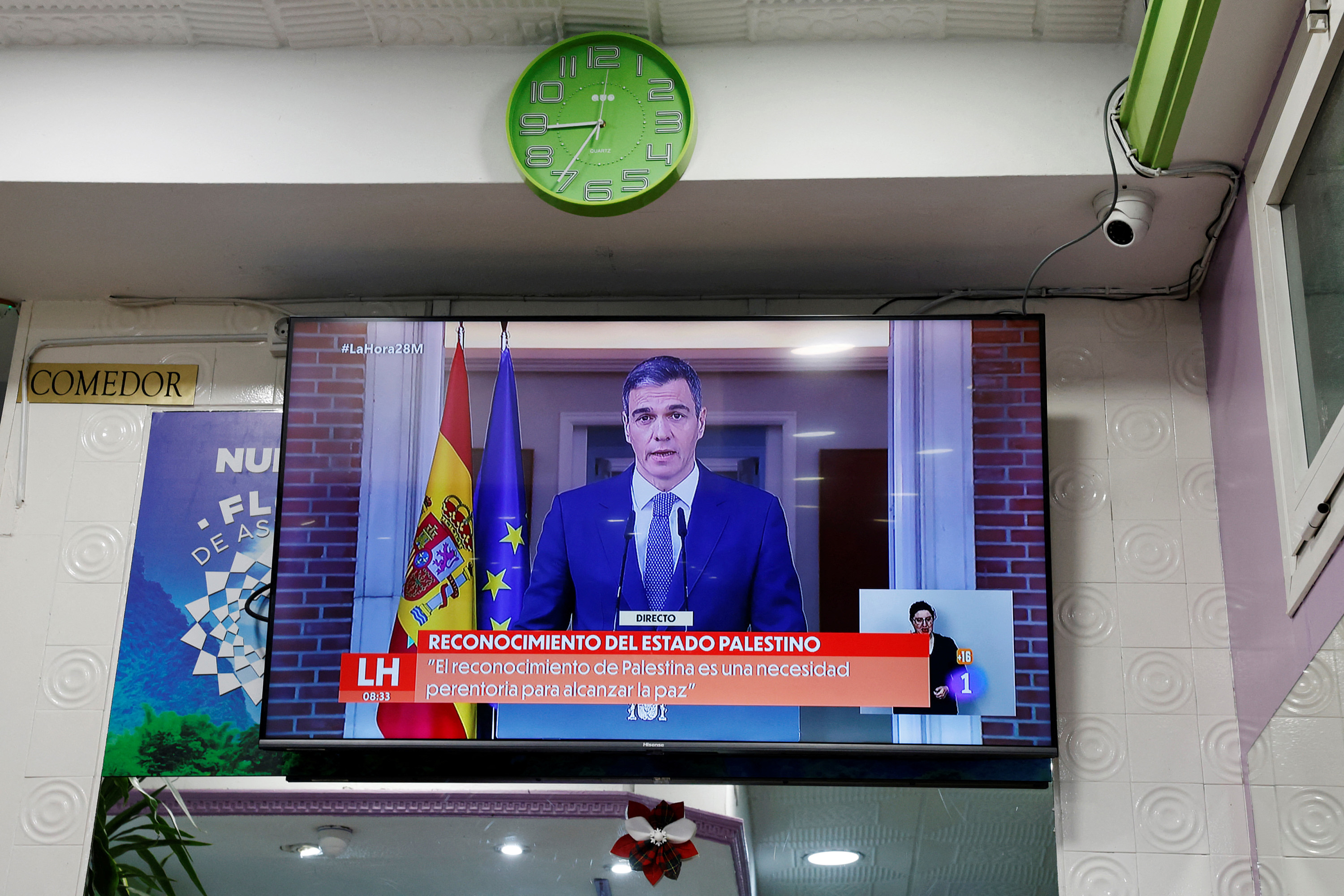 Spain's Prime Minister Pedro Sanchez is seen on a screen in a bar in Madrid, Spain, during a live news TV broadcast announcing Spain's recognition of the Palestinian state, on May 28.