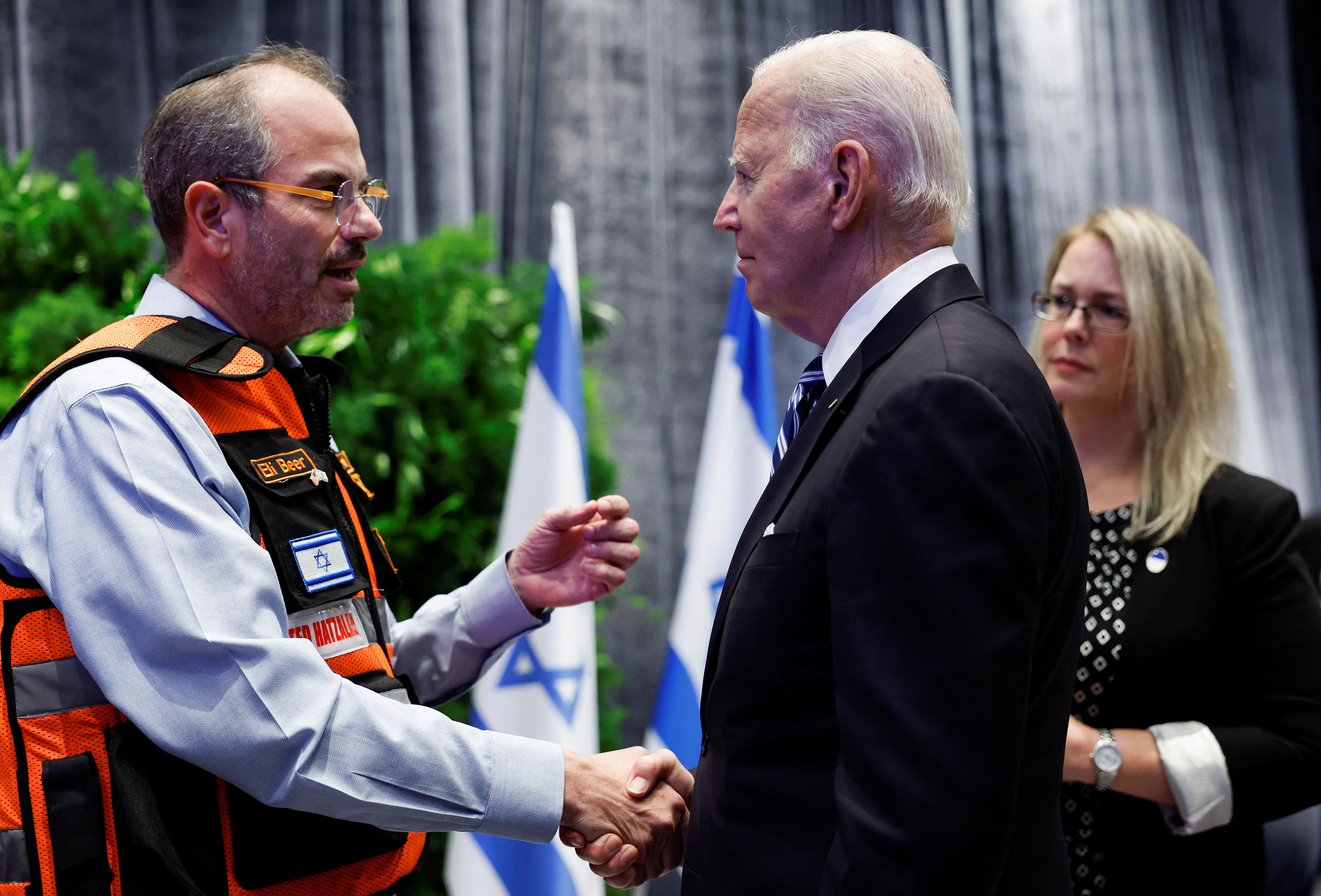 President Joe Biden shakes hands with Eli Beer during a meeting with Israeli first responders, family members and other Israeli citizens in Tel Aviv, Israel, on Wednesday.