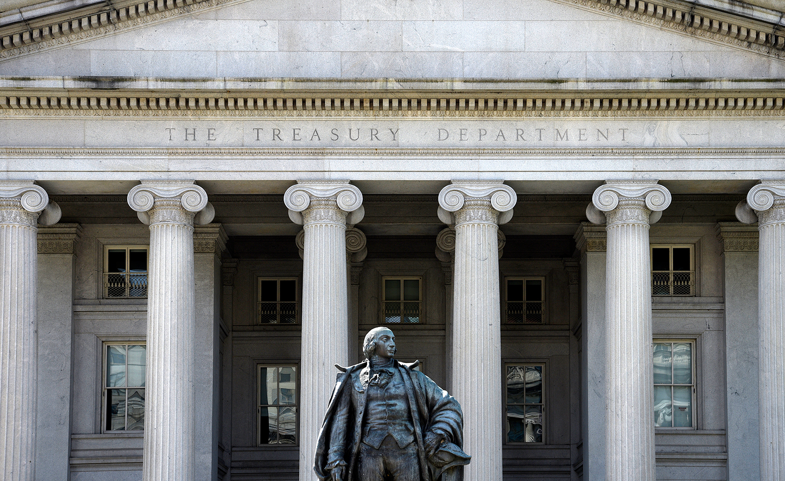 A statue of Albert Gallatin, a former U.S. Secretary of the Treasury, stands in front of The Treasury Building in Washington, D.C. on April 22, 2018.