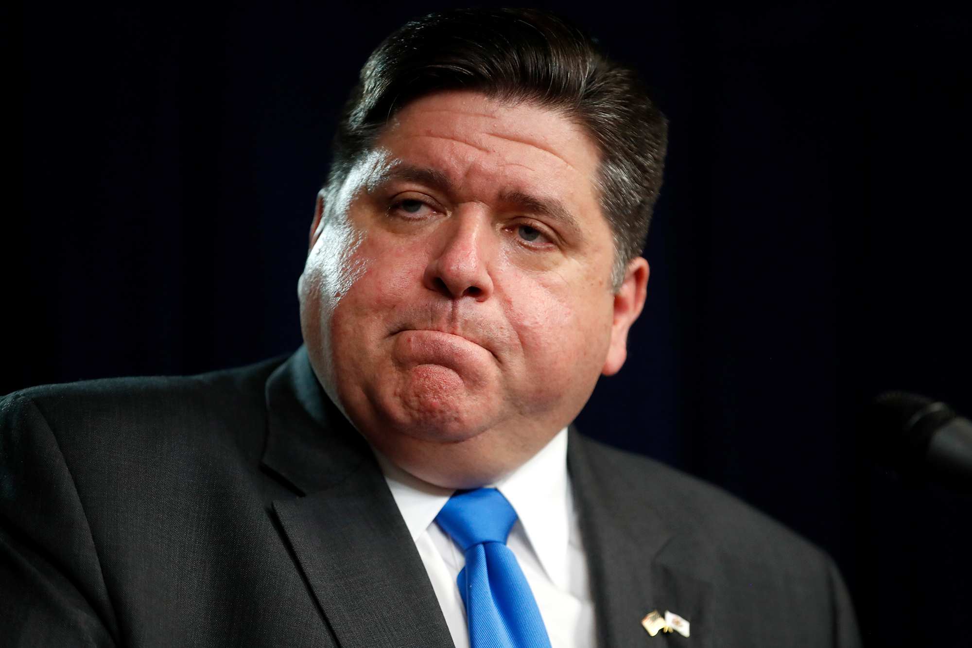 Illinois Gov. J.B. Pritzker listens to a question after announcing a shelter-in-place order to combat the spread of the coronavirus during a news conference Friday, March 20, in Chicago.