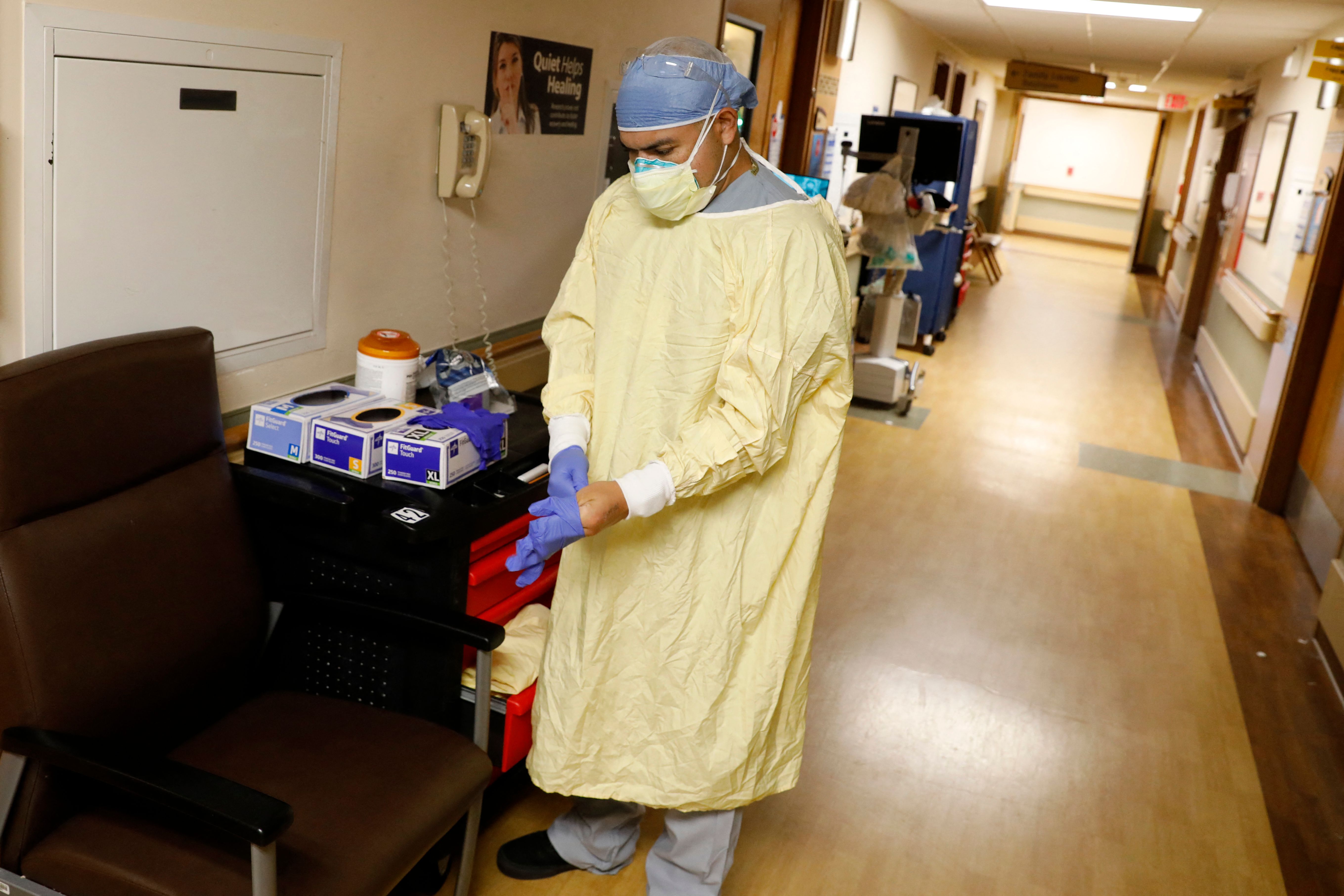 US Army Critical Care Nurse, Captain Edward Rauch Jr., prepares to enter a room of a Covid-19 patient on a ventilator at Beaumont Hospital in Dearborn, Michigan, on December 17, 2021. - Beaumont Hospital is assisted by 23 military medical personnel from the US Army, sent by the Department of Defense, to assist during the health system's fourth Covid-19 surge. 