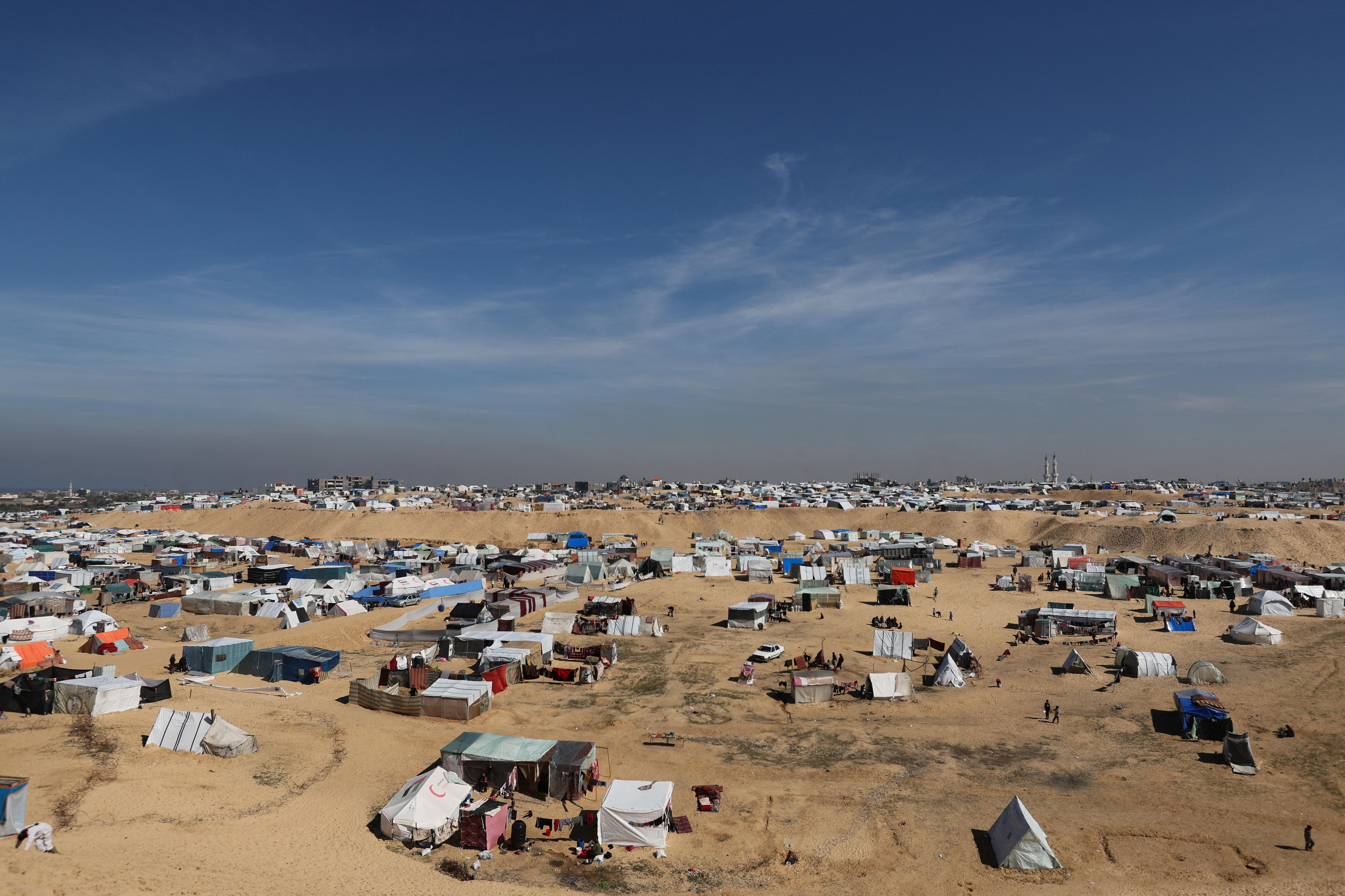 Displaced Palestinians, who fled their houses due to Israeli strikes, take shelter in a tent camp in Rafah, Gaza, near the border with Egypt on February 8.