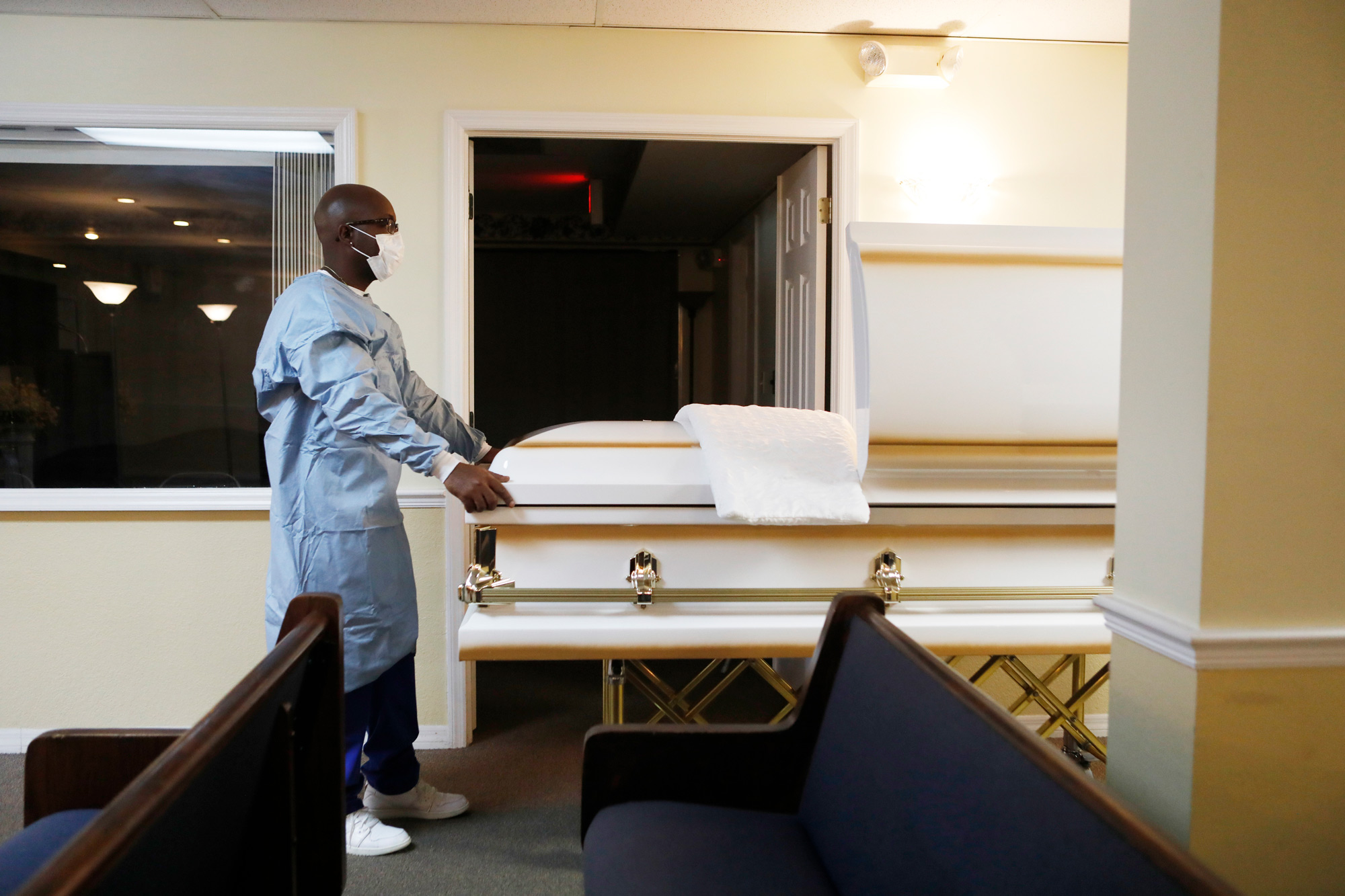 Marlon Warren, a mortician assistant prepares a funeral service for a man who died of COVID-19 at Ray Williams Funeral Home on August 12 in Tampa, Florida.