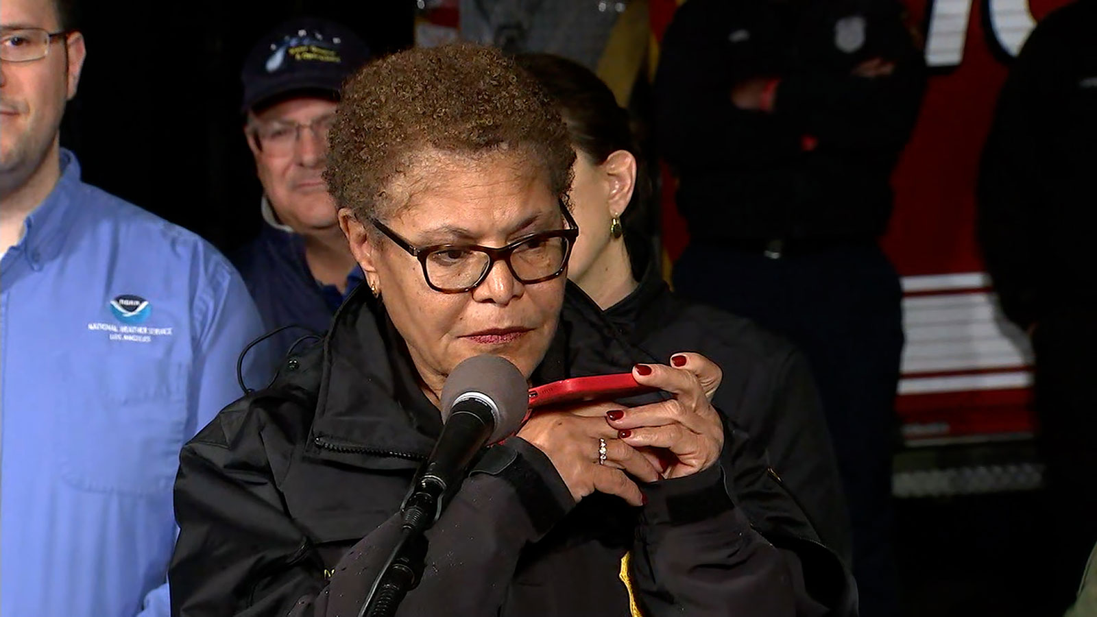 Los Angeles Mayor Karen Bass holds a phone to the microphone to allow President Biden to make remarks  during a press conference on Monday, February, 5. 