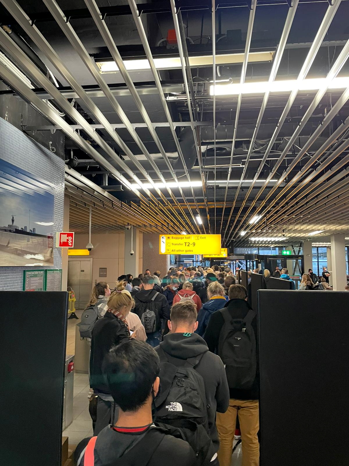 Passengers travelling from South Africa queue to be coronavirus disease (COVID-19) tested after being held on the tarmac at Schiphol Airport, Netherlands November 26th, 2021, in this picture obtained from social media
