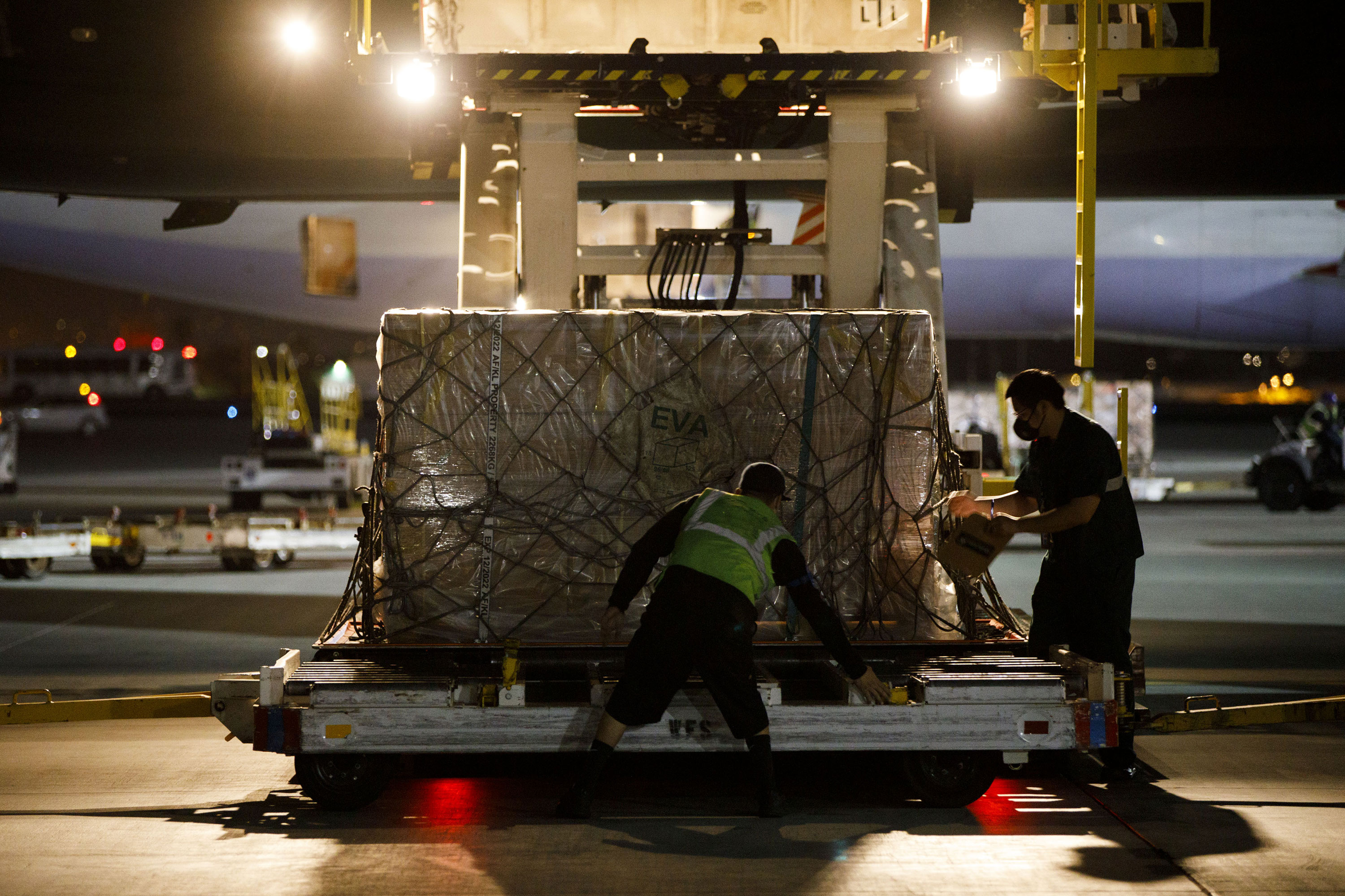 Ground crew workers unload a FEMA Project Airbridge delivery of PPE from Taipei, Taiwan, at Los Angeles International Airport on May 7.