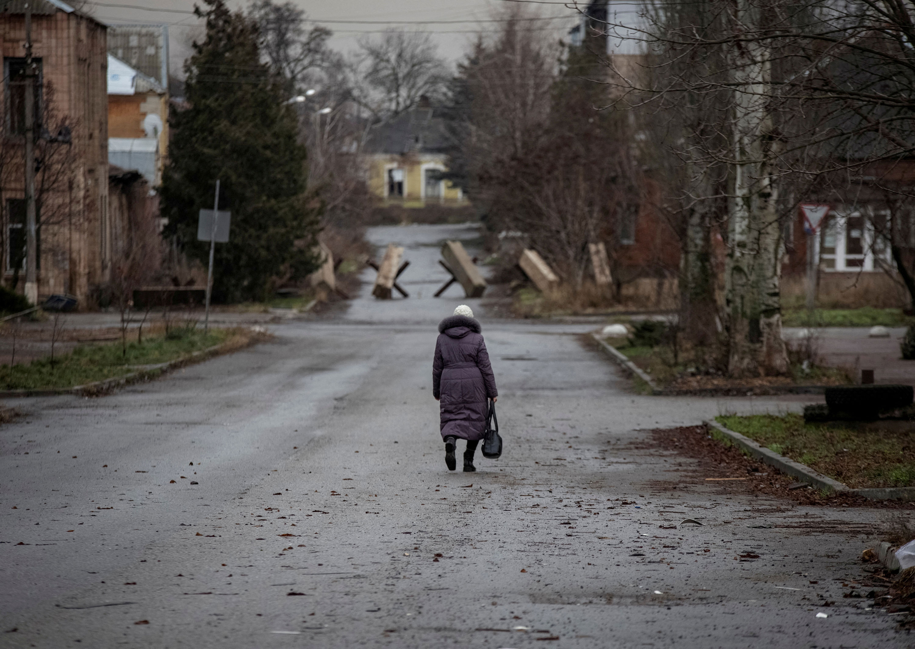 A person walks down an empty street in Bakhmut, Ukraine, on December 18.