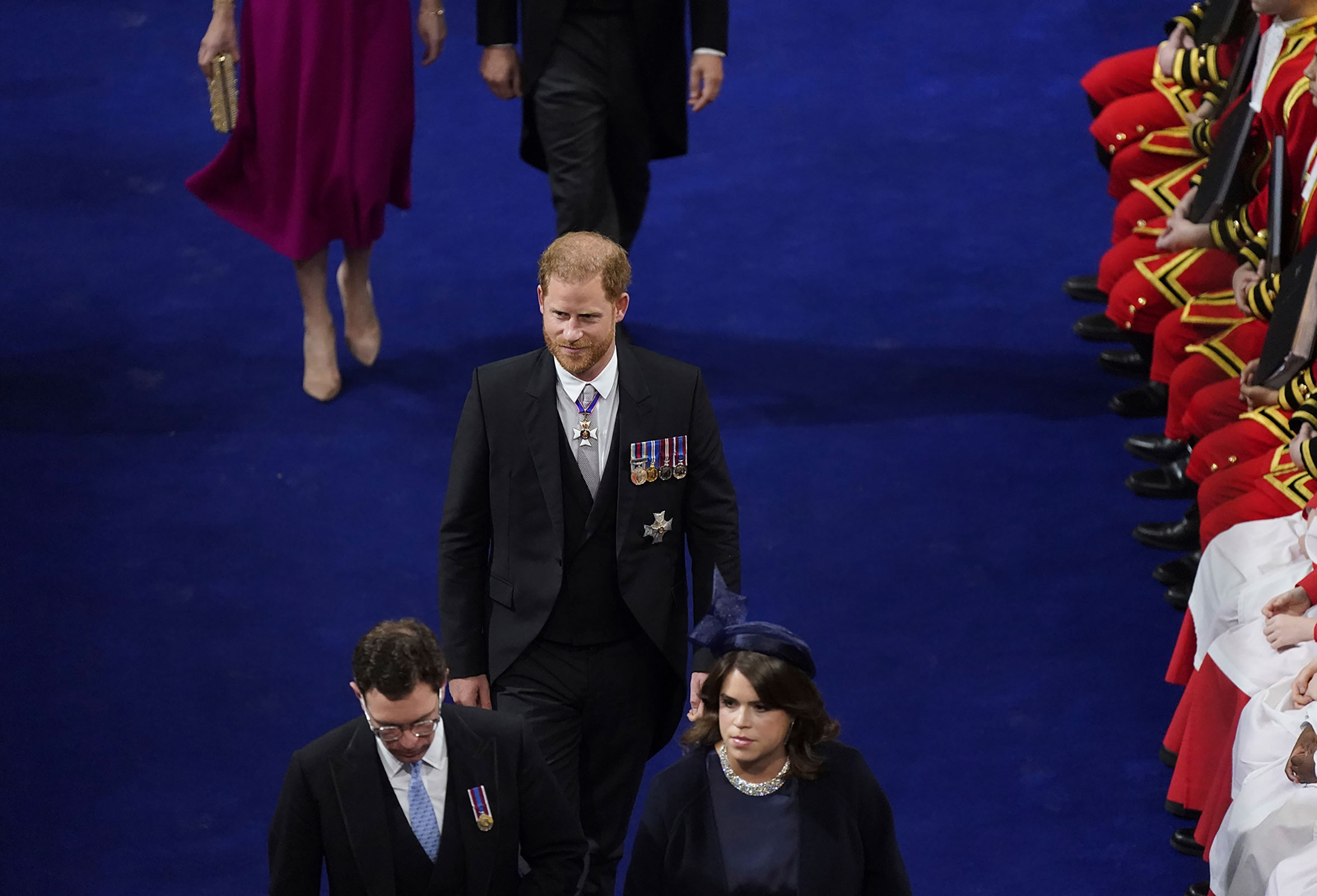 Prince Harry, William's brother, enters Westminster Abbey. He accepted the invitation to his father's coronation but was without his wife, Meghan, who stayed back in California with the couple's two children. 