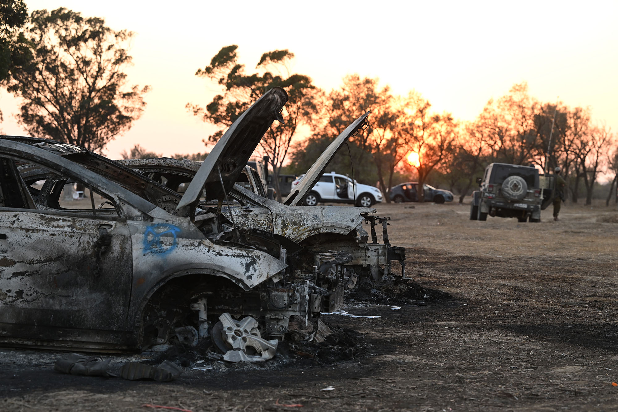 Burnt out cars at the scene as Israeli soldiers continue to search for ID and belongings among the cars and tents at the Nova Music Festival site in Israel on October 12.