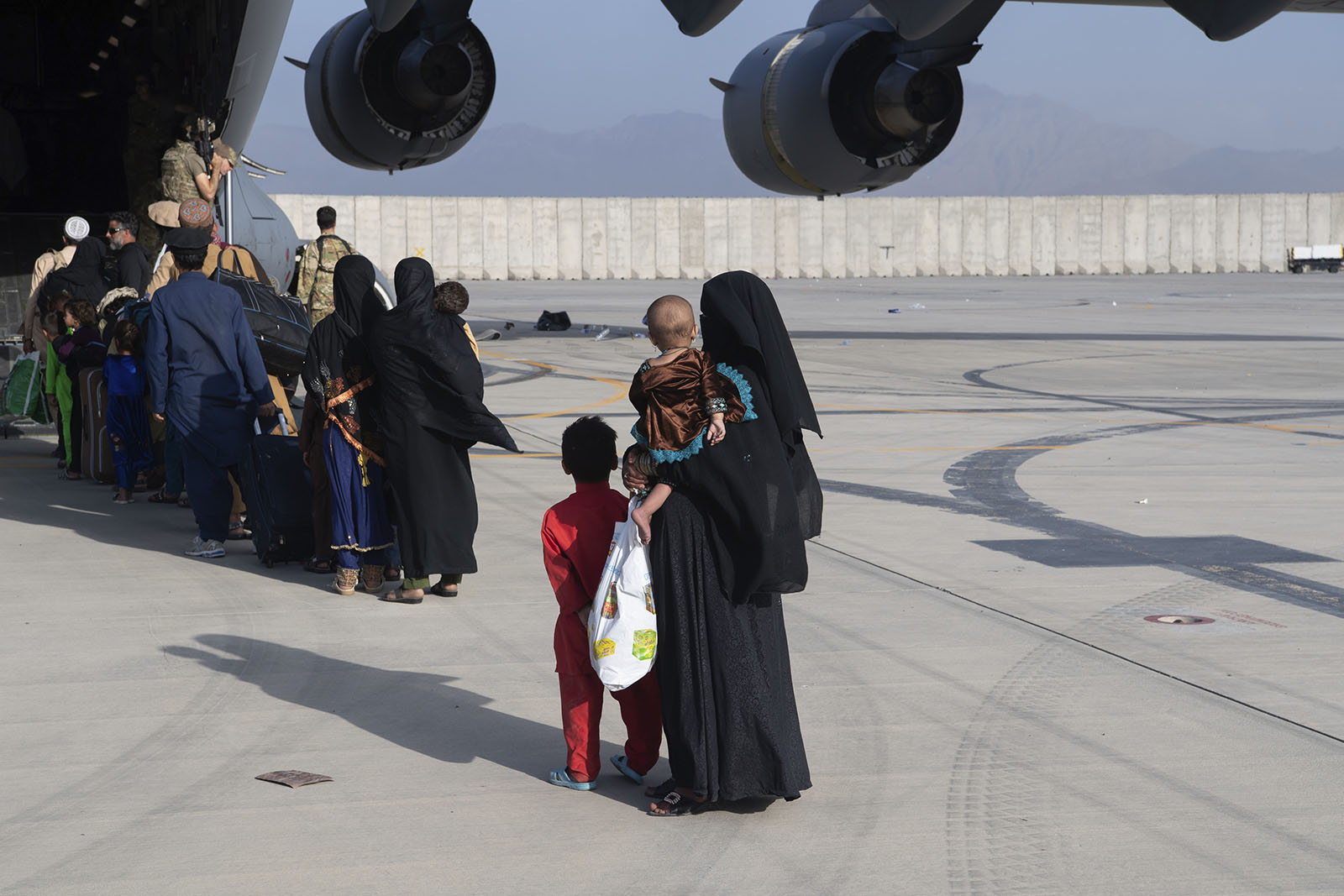 People board a U.S. Air Force C-17 Globemaster III as they evacuate from Hamid Karzai International Airport on August 24. 