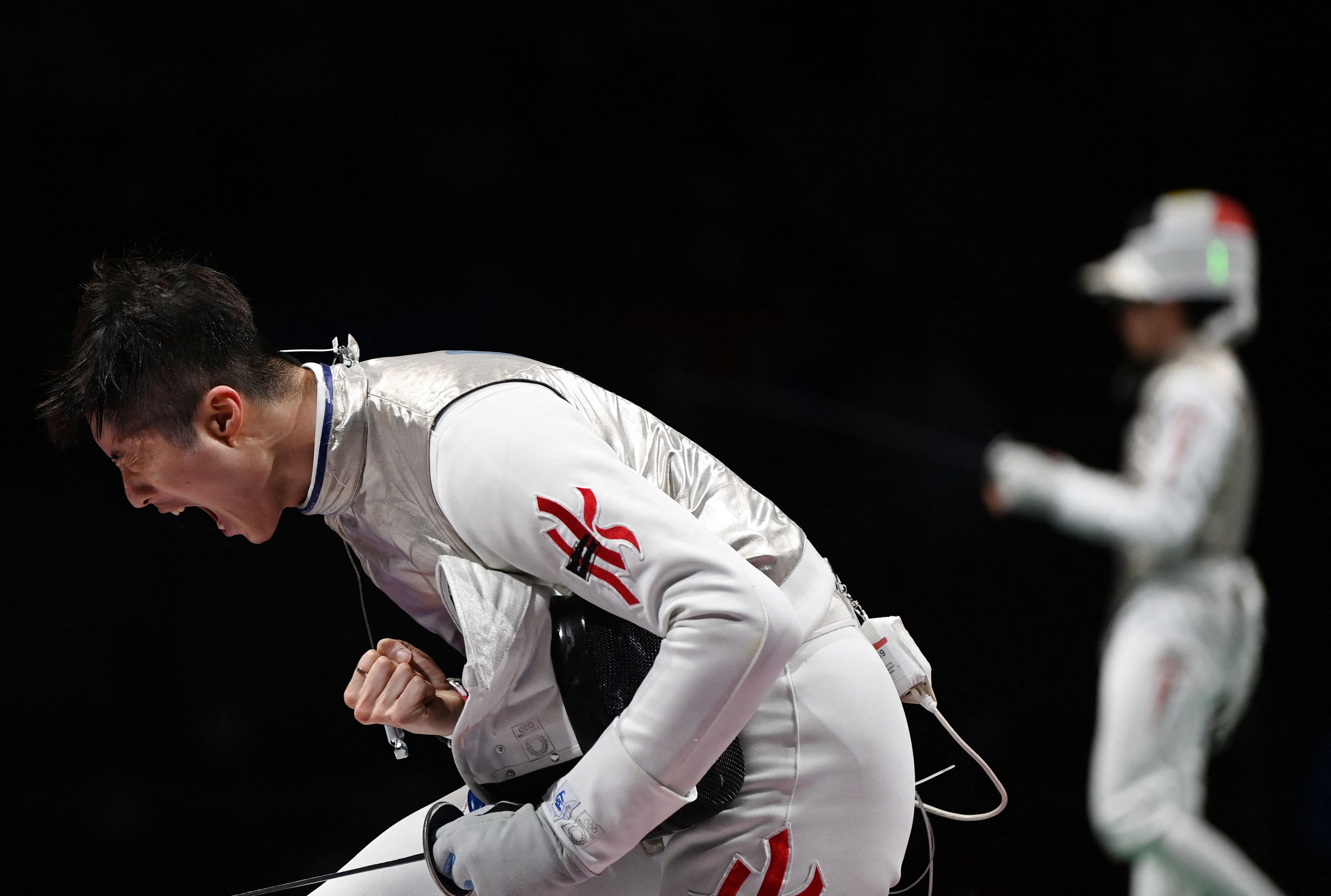 Hong Kong's Edgar Cheung celebrates after winning against Italy's Alessio Foconi in the individual foil qualifying bout on July 26.