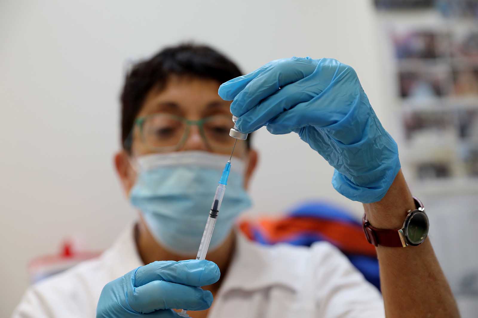 A medical worker prepares a dose of the COVID-19 vaccine at a healthcare center in Modiin, Israel, on July 5.