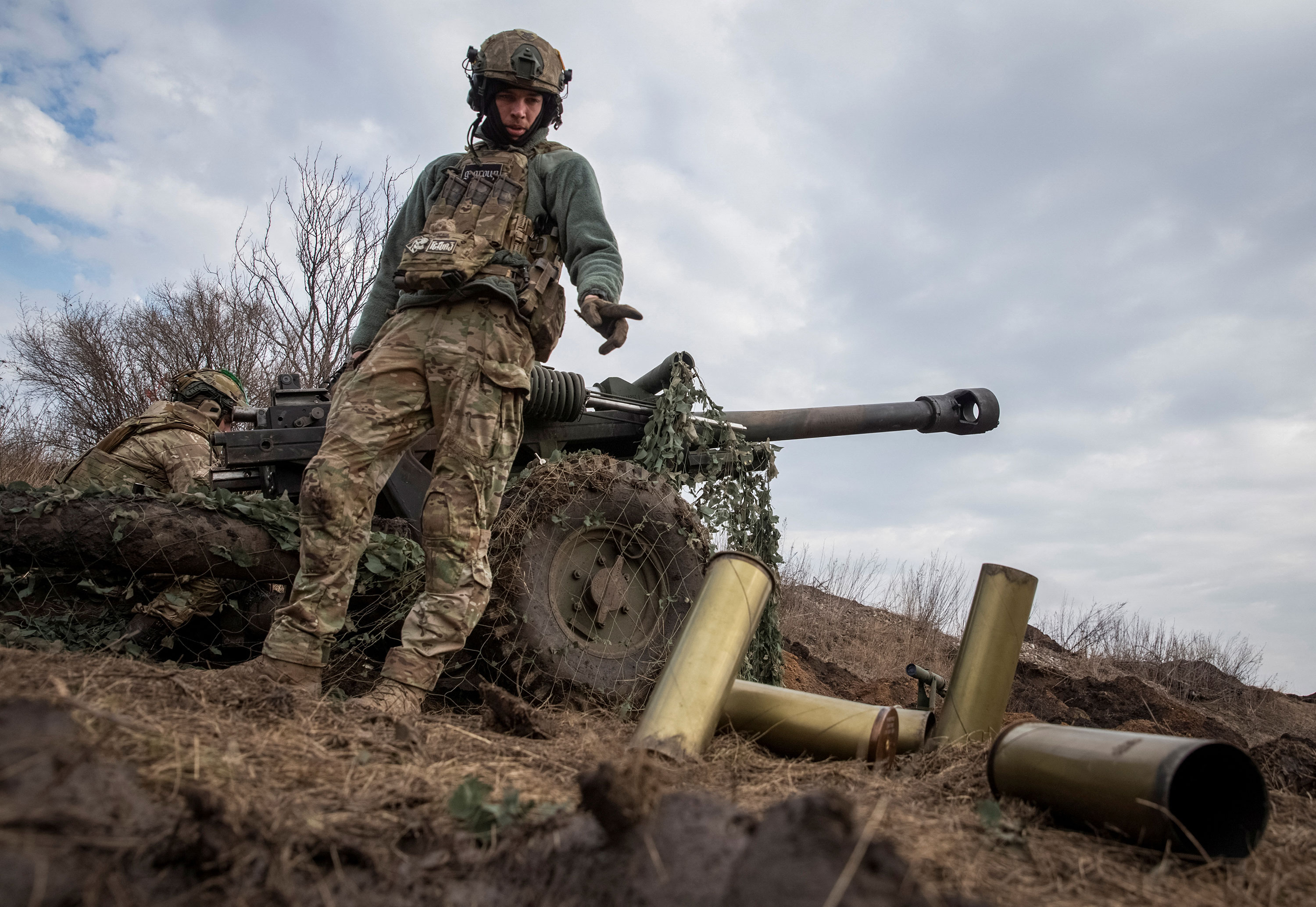 Ukrainian service members fire a howitzer at a front line near the city of Bakhmut on March 10. 