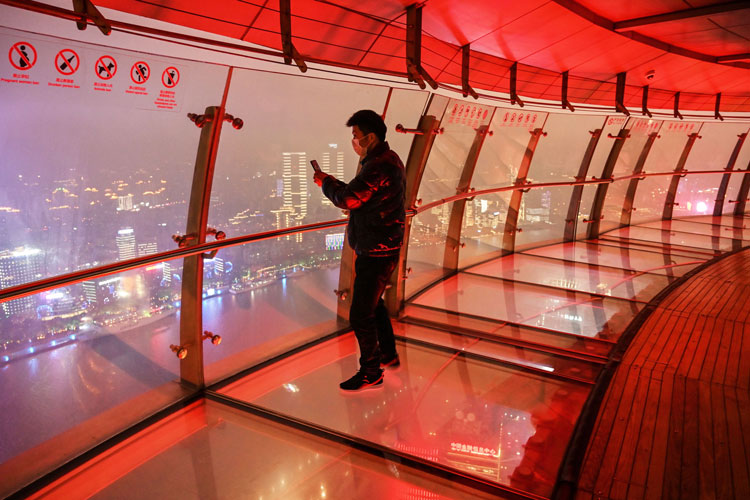 A man takes photos of Shanghai from the Oriental Pearl Tower Radio and Television Tower in Shanghai on March 12.