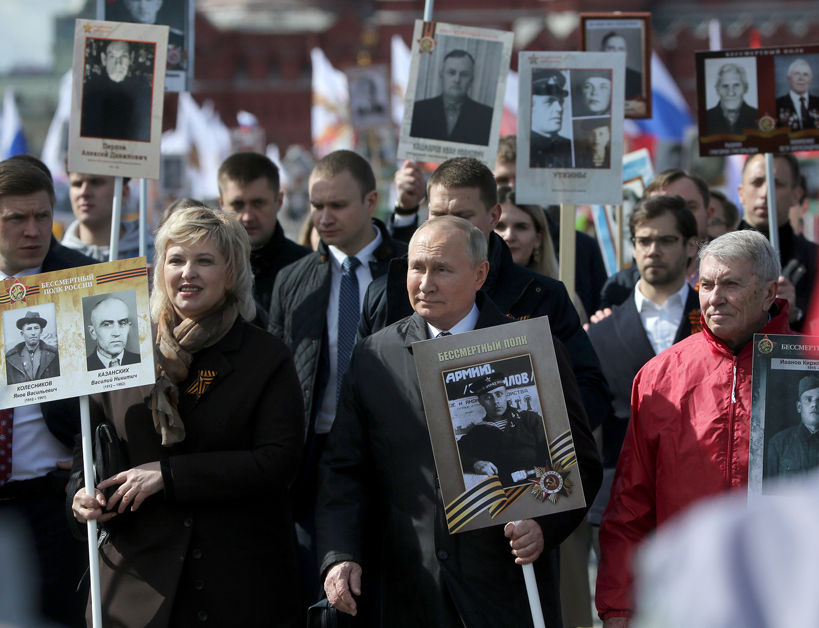 Russian President Vladimir Putin, center, holds a portrait of his father during the Immortal Regiment march, after the Victory Day Parade on May 9, in Moscow, Russia.