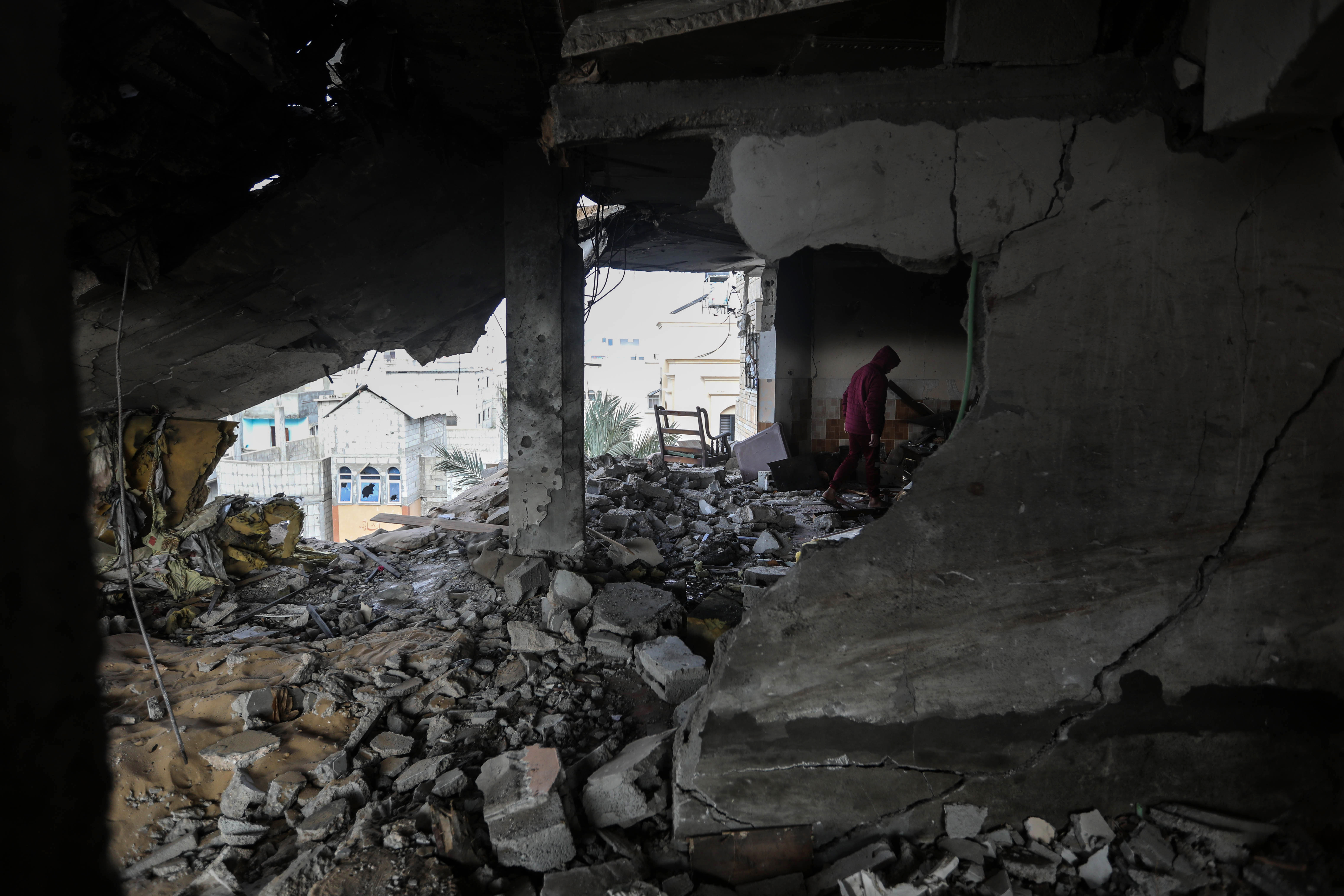 People inspect the damage to their homes following Israeli airstrikes in Rafah, Gaza, on February 10.