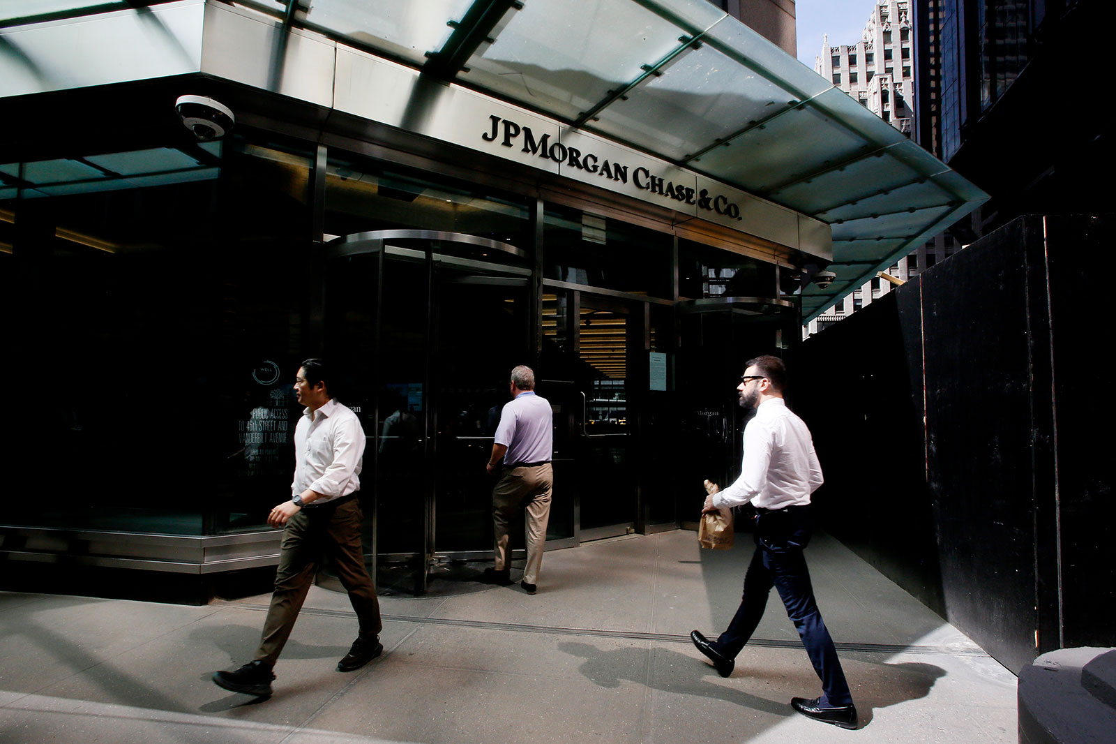 People walk near a J.P.Morgan Chase & Co branch on April 14 in New York. 