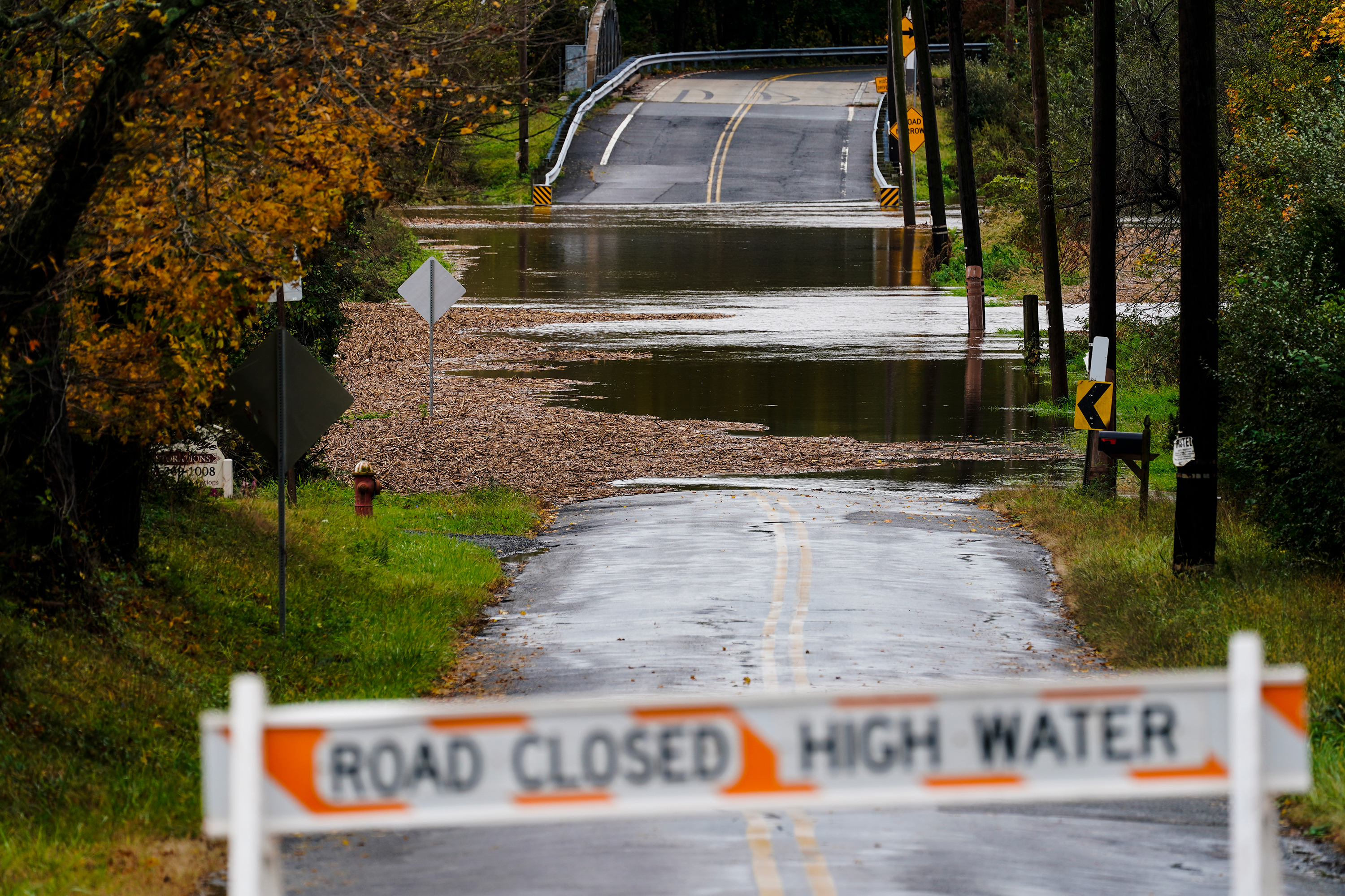 A barricade blocks access to a road flooded by rain in Branchburg, New Jersey, on Tuesday, October 26. 