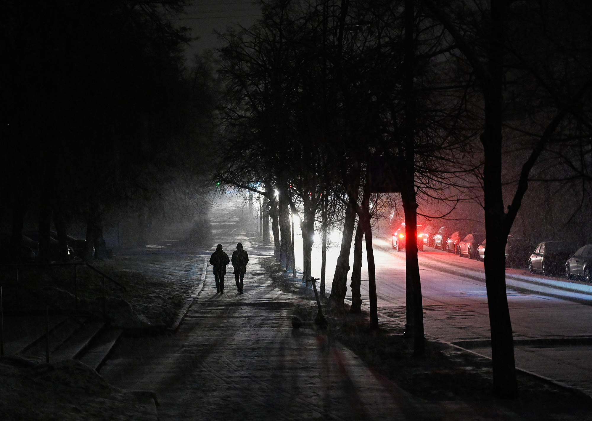 People walk down a dark street in Kyiv, Ukraine, during an energy black out on December 26.