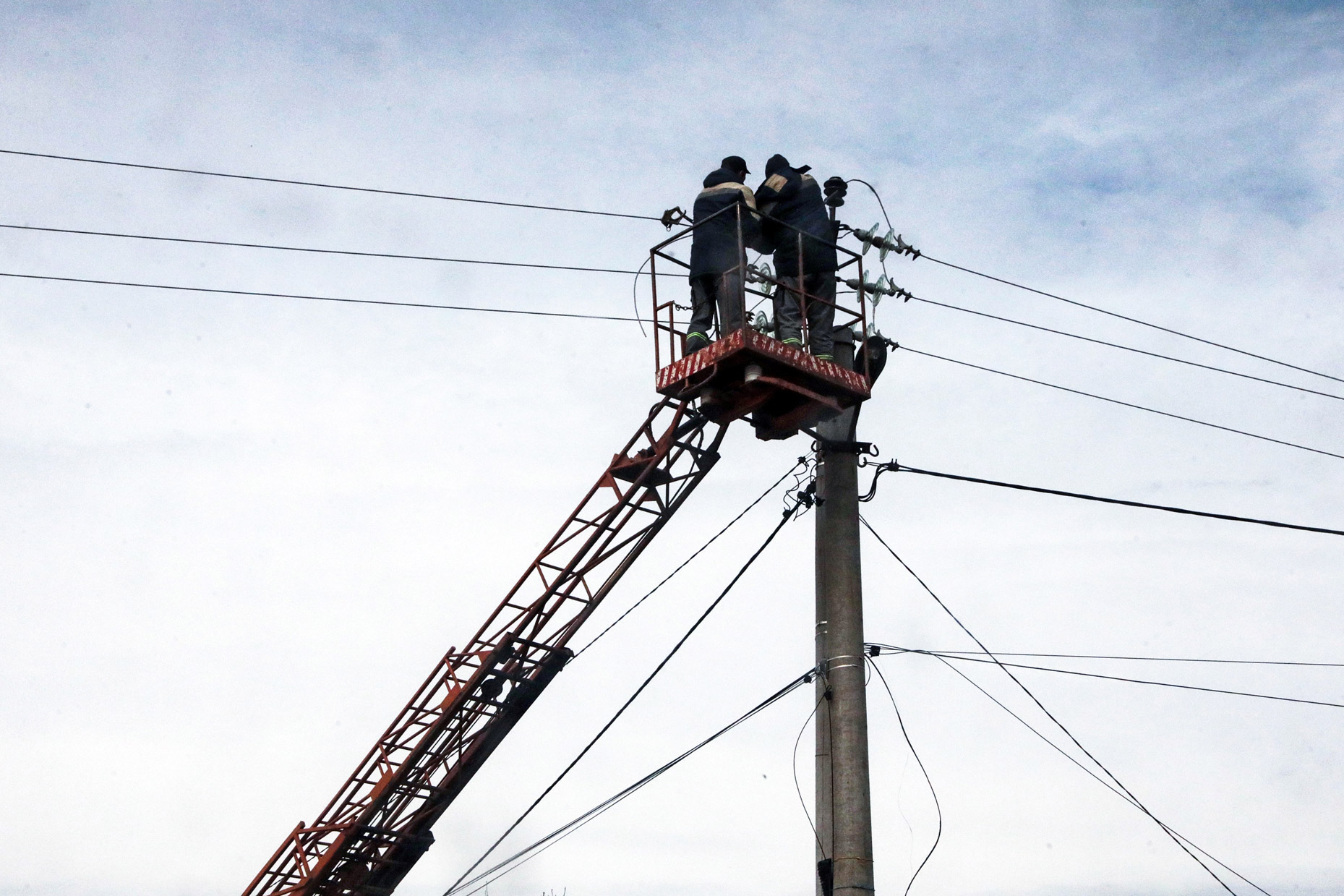 Workers repair power lines in Hostomel, Kyiv Region, north-central Ukraine on April 8.