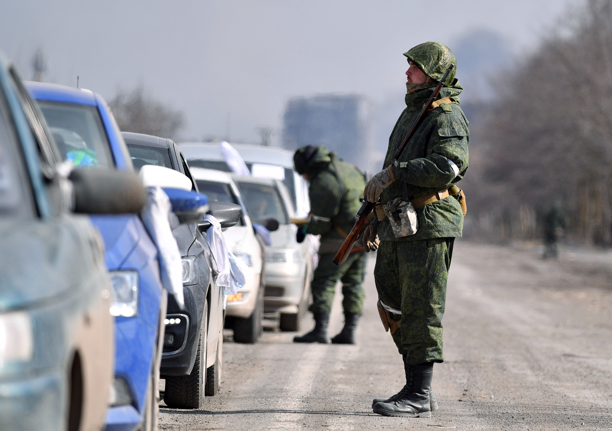 Servicemen of the self-declared DPR People's Militia check the documents of residents leaving Mariupol, Ukraine, on March 16.