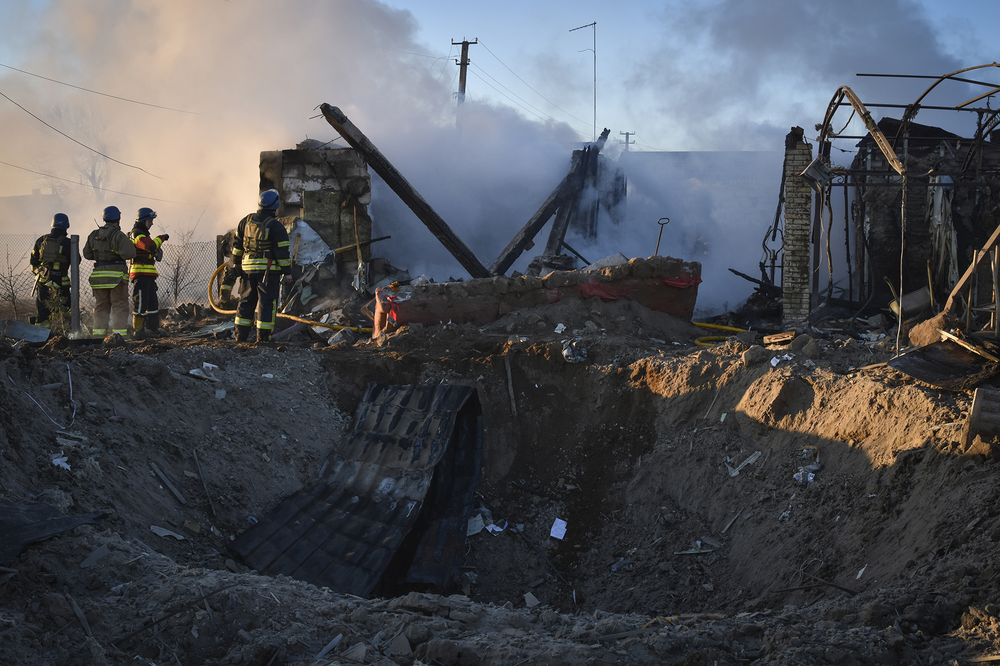Members of the Ukrainian State Emergency Service clear the rubble after a strike in Zaporizhzhia district, Ukraine, on March 31.