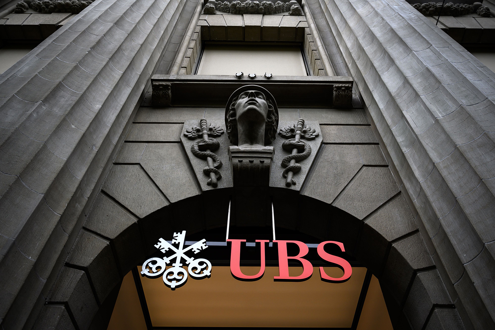 A sign of Swiss banking giant UBS is seen on their headquarters in May 2019 in Zurich, Switzerland..