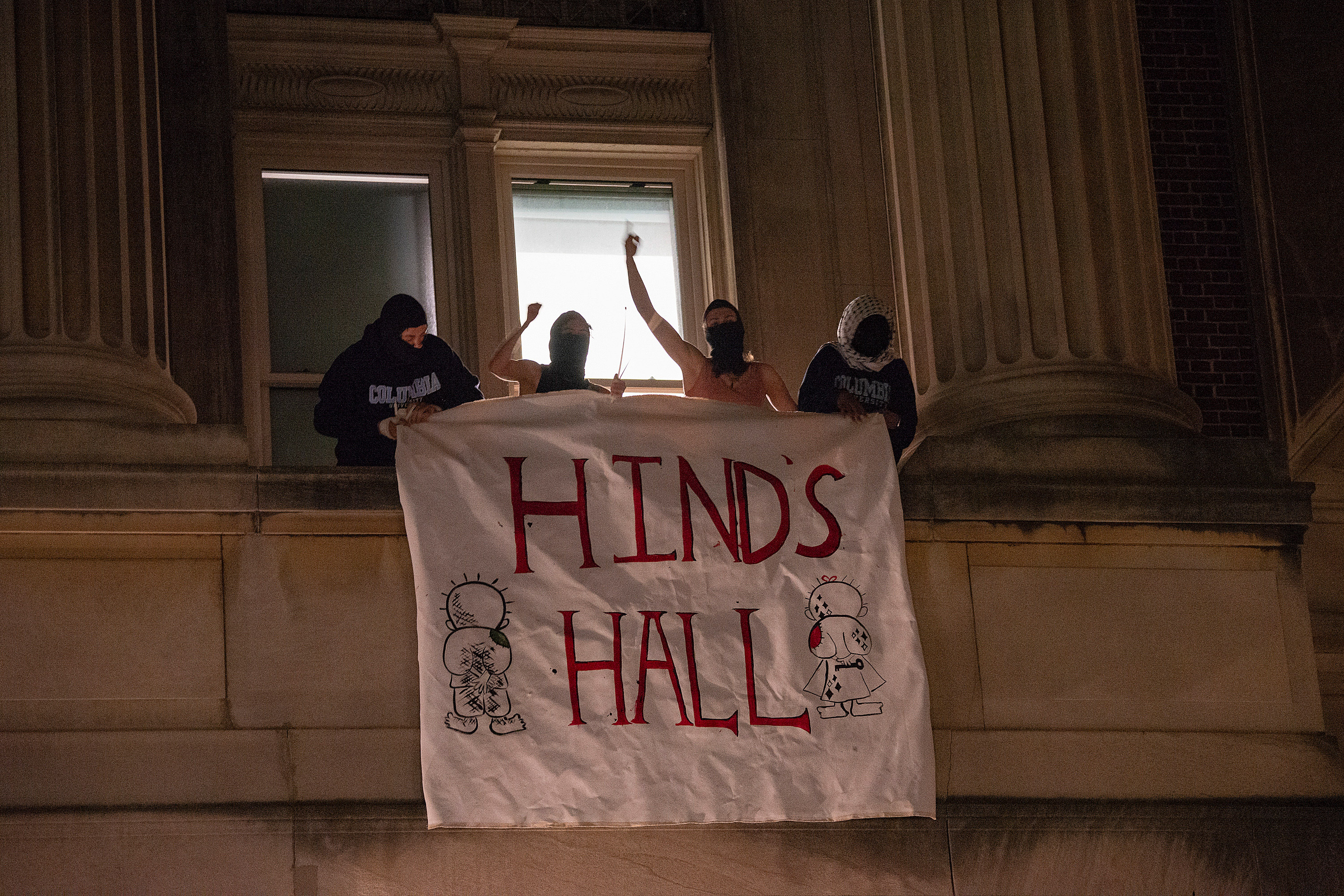 People hang a banner outside of Hamilton Hall at Columbia University in New York in the early hours of Tuesday.