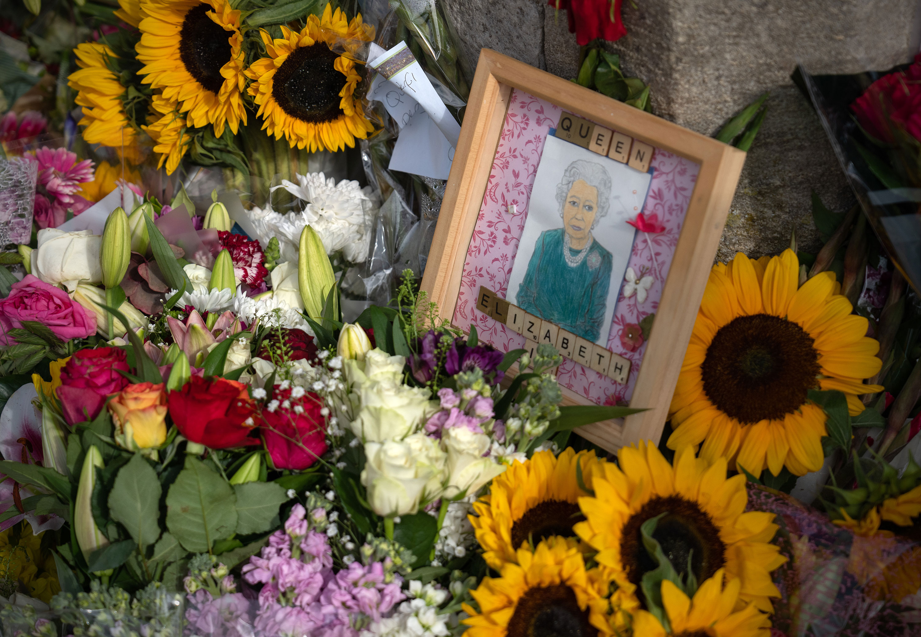 Flowers and tributes are left outside Windsor Castle on Monday.
