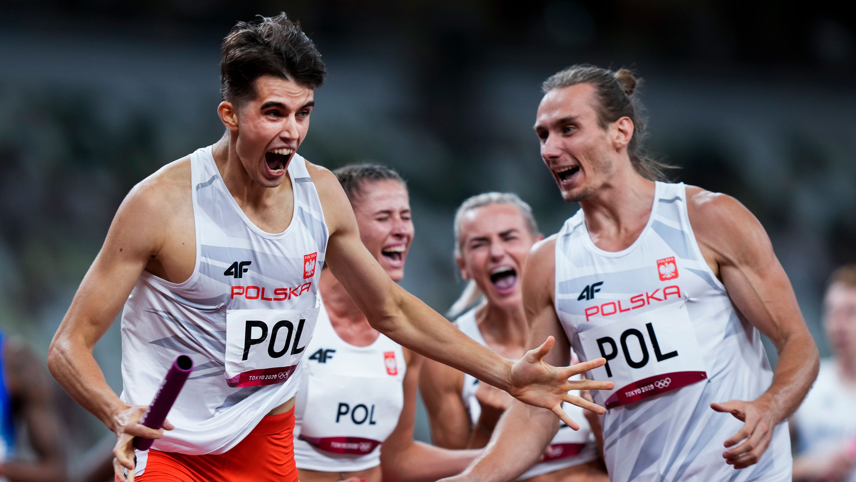 Team Poland celebrates after winning the 4x400 meter mixed relay final on July 31.