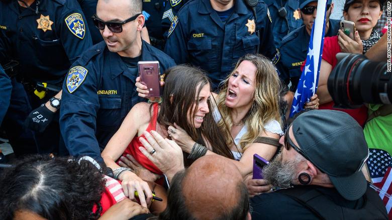 In this Friday photo, protester Heidi Munoz Gleisner, center left, is removed from a demonstration against California Governor Gavin Newsom's stay-at-home order. 