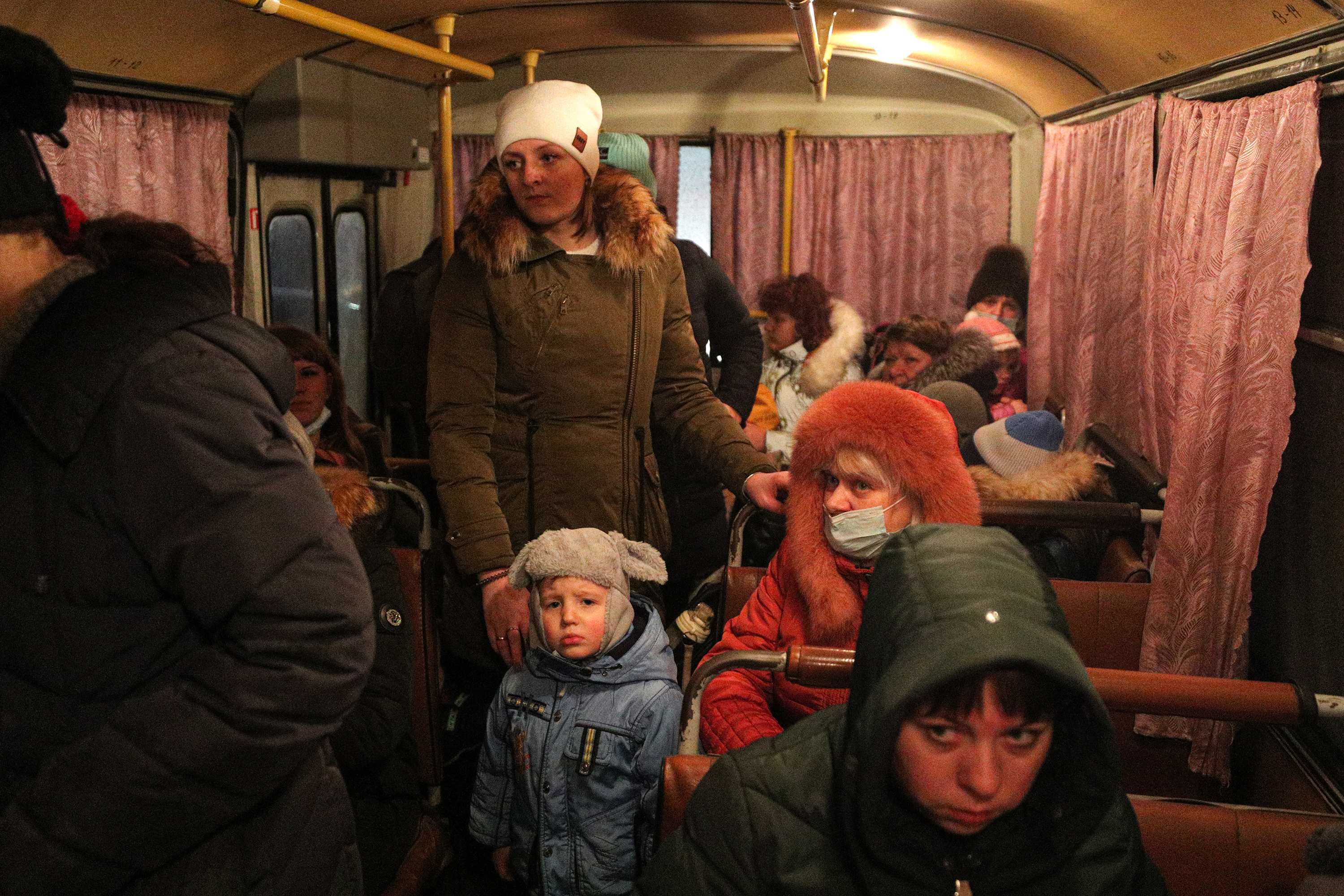 People are seen inside a bus in Donetsk, Ukraine, on Friday, February 18, after pro-Russian separatists in eastern Ukraine's breakaway regions ordered the evacuation of civilians to Russia. 