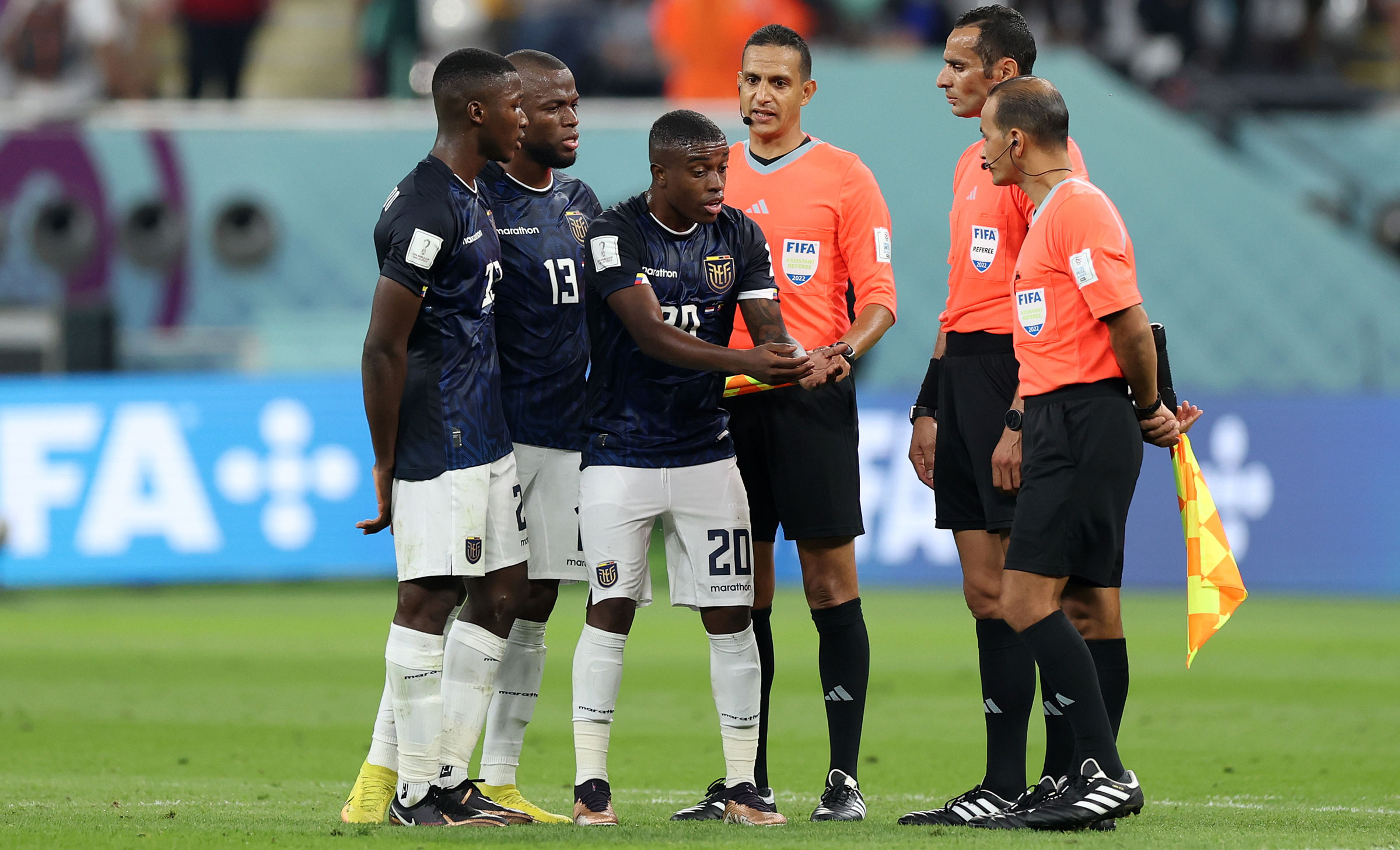 Ecuador players dispute a disallowed goal that happened at the end of the first half.