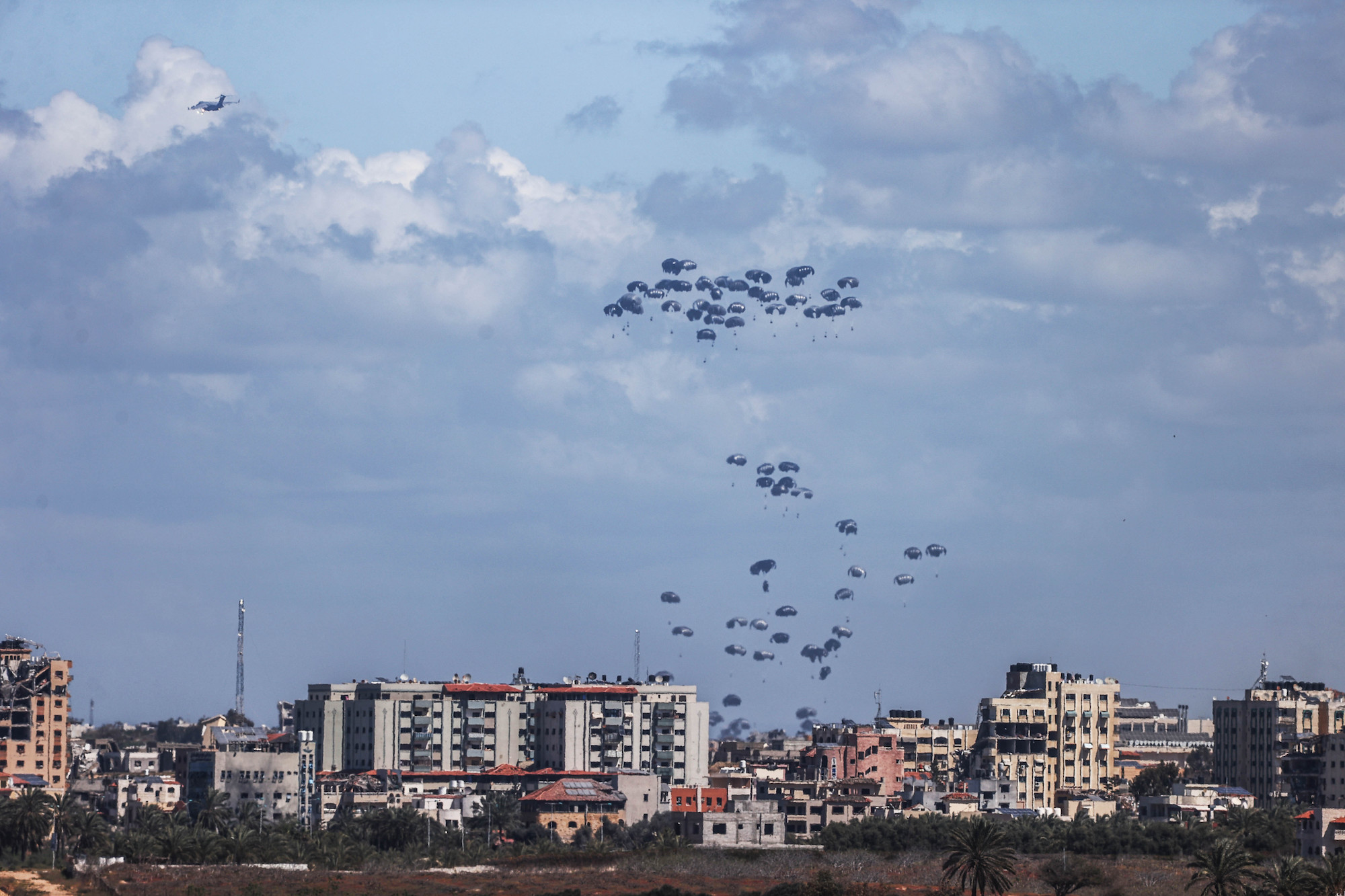 Planes drop humanitarian aid over Gaza City, Gaza on Friday.