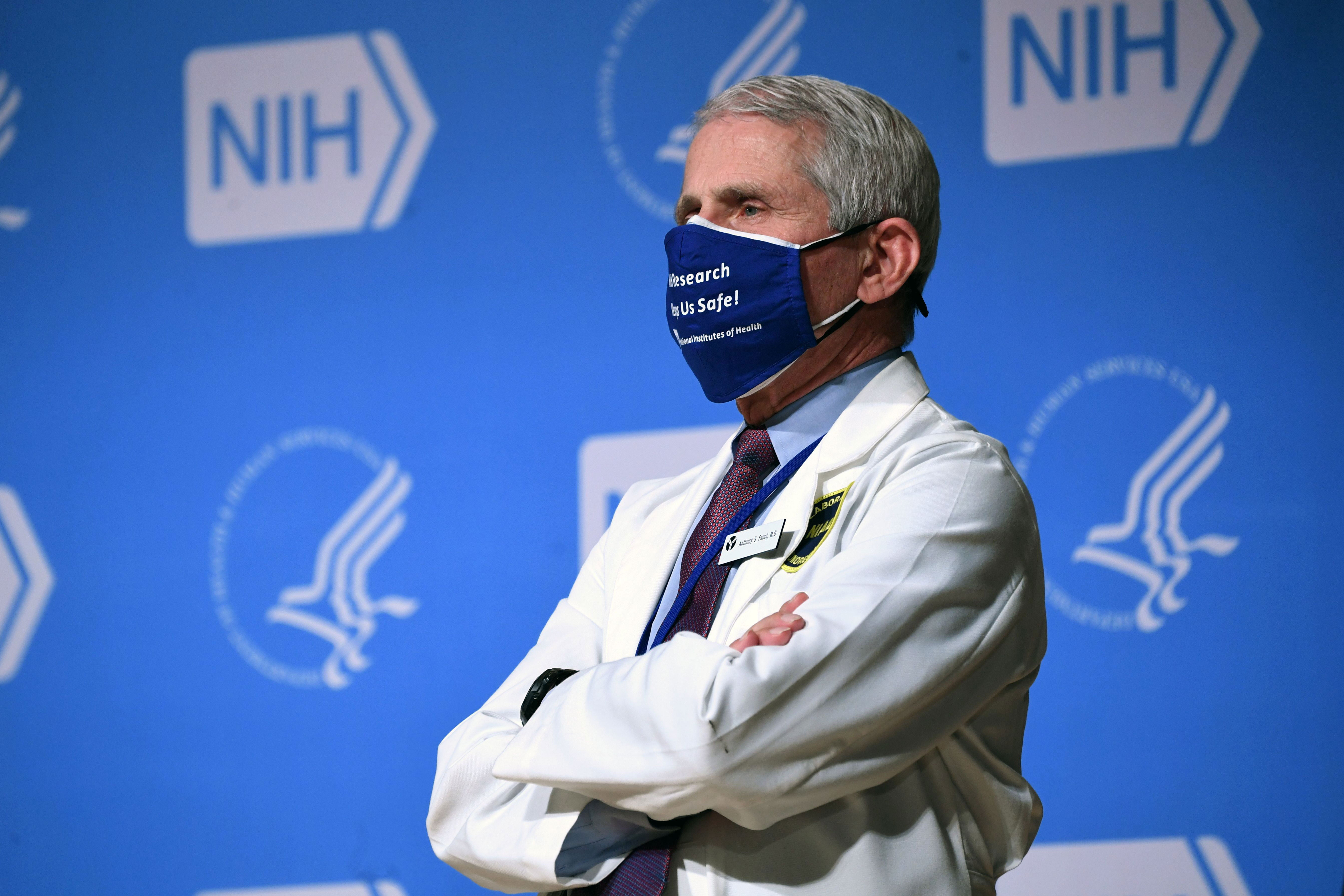 Dr. Anthony Fauci listens to US President Joe Biden, out of frame, during a visit to the National Institutes of Health in Bethesda, Maryland, on February 11.