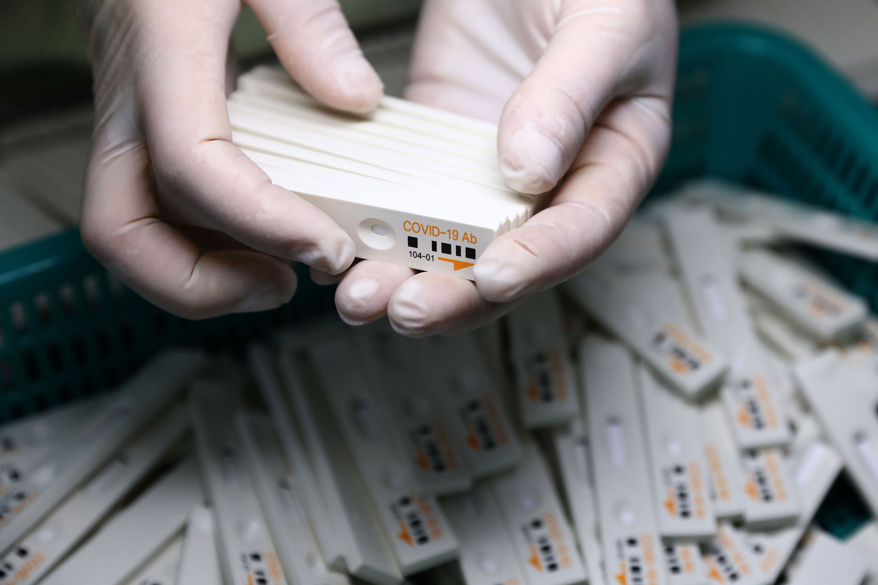 An employee holds coronavirus testing kits at the Boditech Med Inc. headquarters on April 17, in Chuncheon, South Korea.