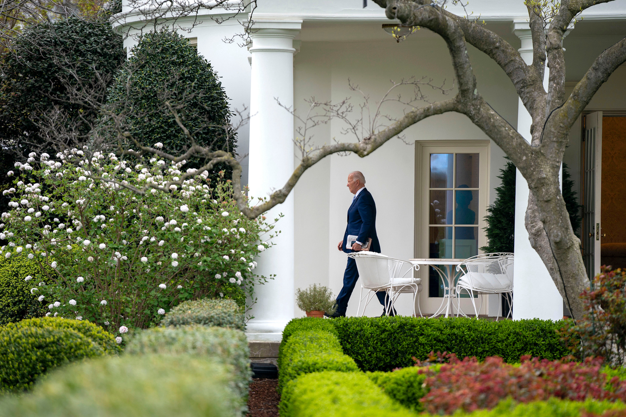 President Joe Biden exits the Oval Office of the White House before boarding Marine One on March 22.