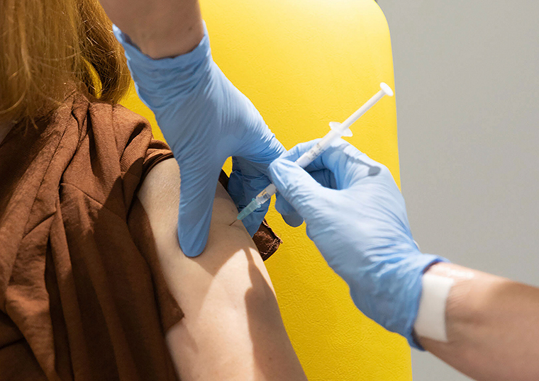 A volunteer is administered the coronavirus vaccine developed by AstraZeneca and Oxford University, in Oxford, England. 