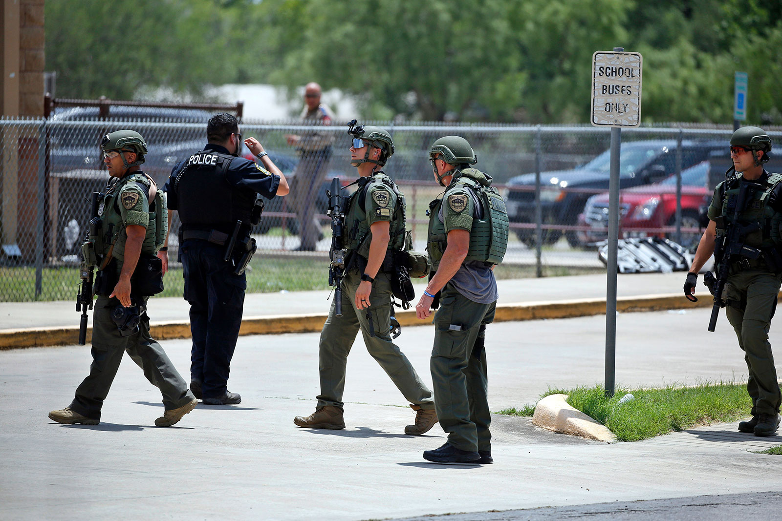 Law enforcement personnel stand outside Robb Elementary School following a shooting on May 24, in Uvalde, Texas. 