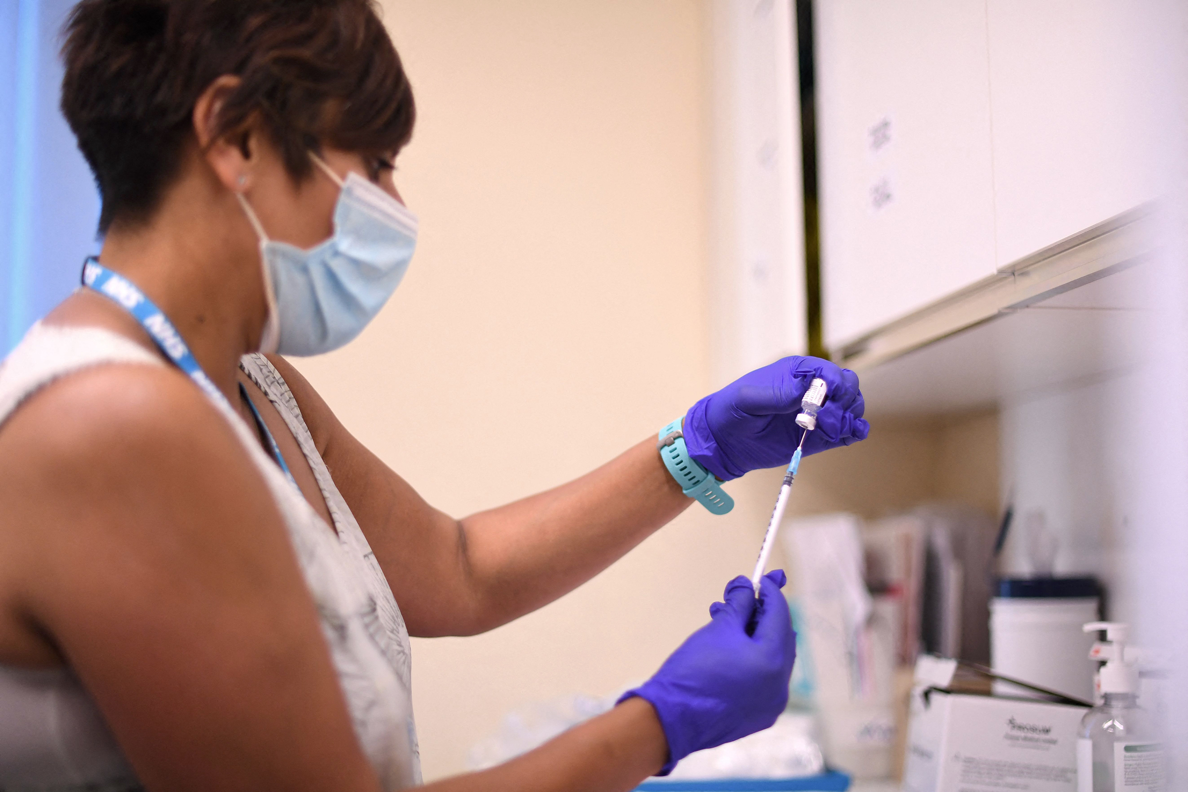 A health worker prepares a dose of the Pfizer/BioNTech Covid-19 vaccine at a vaccination center in London, on June 5. 
