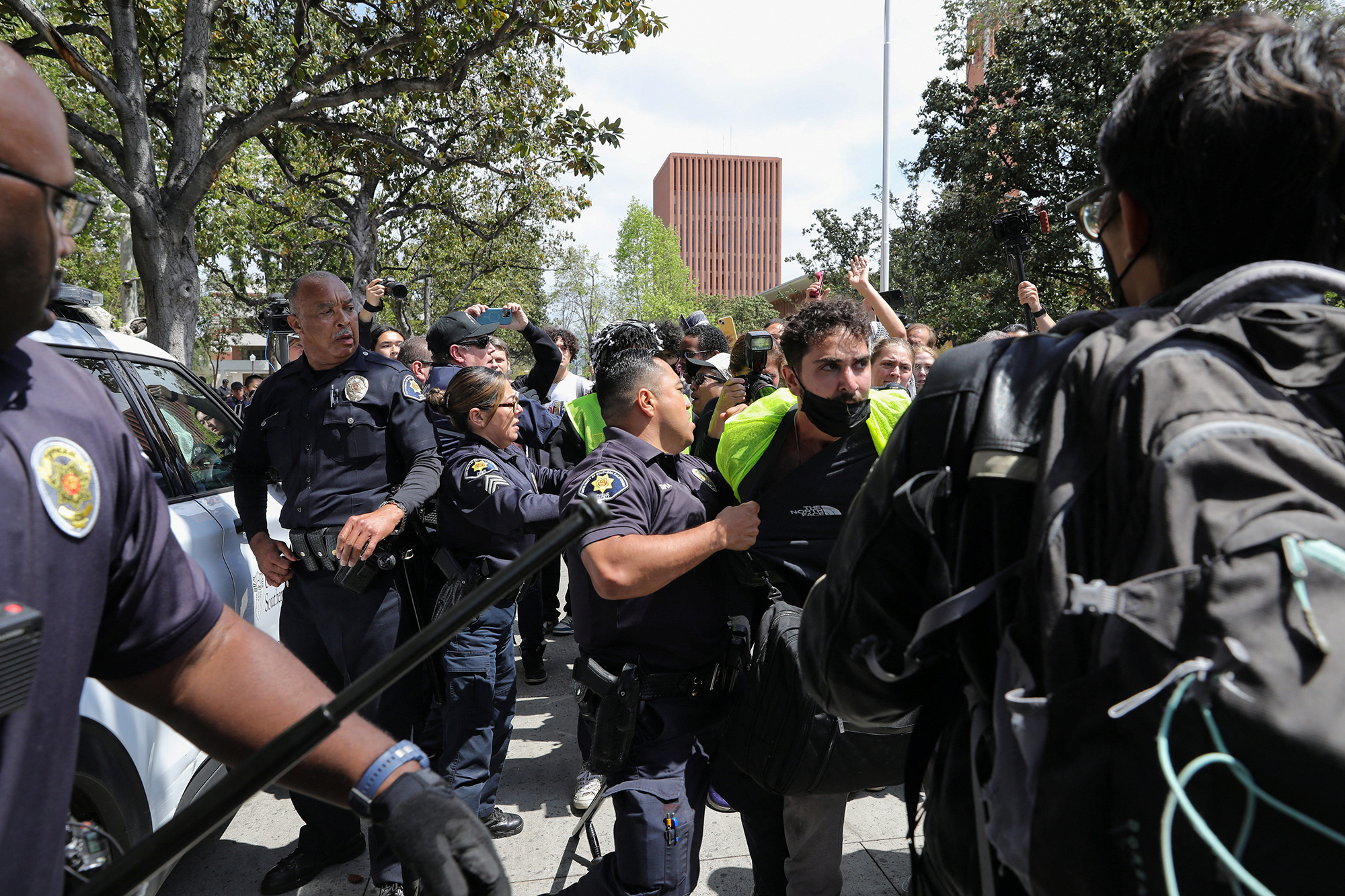 USC Safety officers try to disperse students who protest in support of Palestinians, at the University of Southern California's Alumni Park in Los Angeles, California, on April 24.