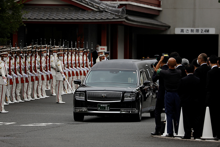 A vehicle carrying the body of the late former Japanese Prime Minister Shinzo Abe, leaves after his funeral at Zojoji Temple in Tokyo, Japan, on July 12.