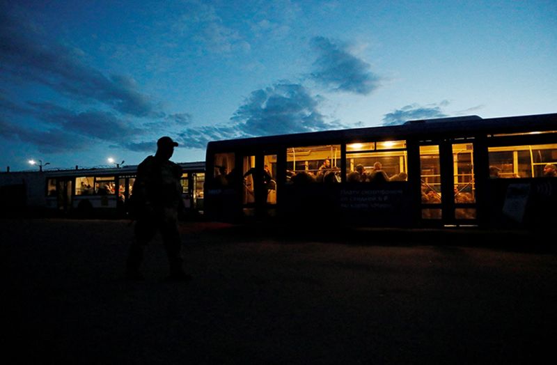 Members of Ukrainian forces are seen inside a bus, which arrived under escort of the pro-Russian military at a detention facility in the settlement of Olenivka in the Donetsk Region, Ukraine on Tuesday.