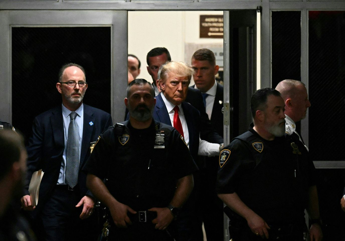 Trump walks through the Manhattan Criminal Courthouse on Tuesday.