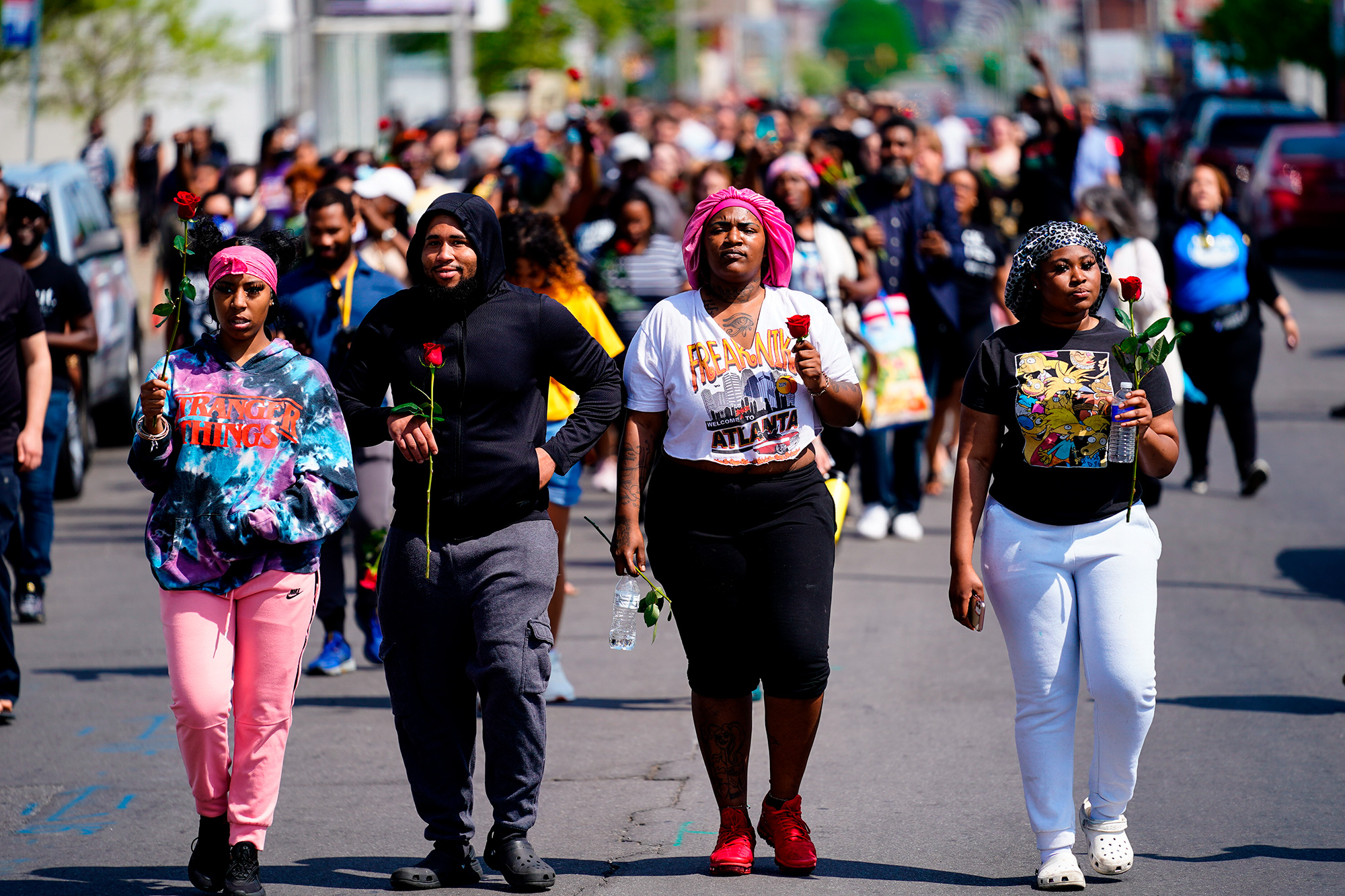 People march to the scene of the mass shooting at a supermarket in Buffalo, New York on Sunday, May 15.