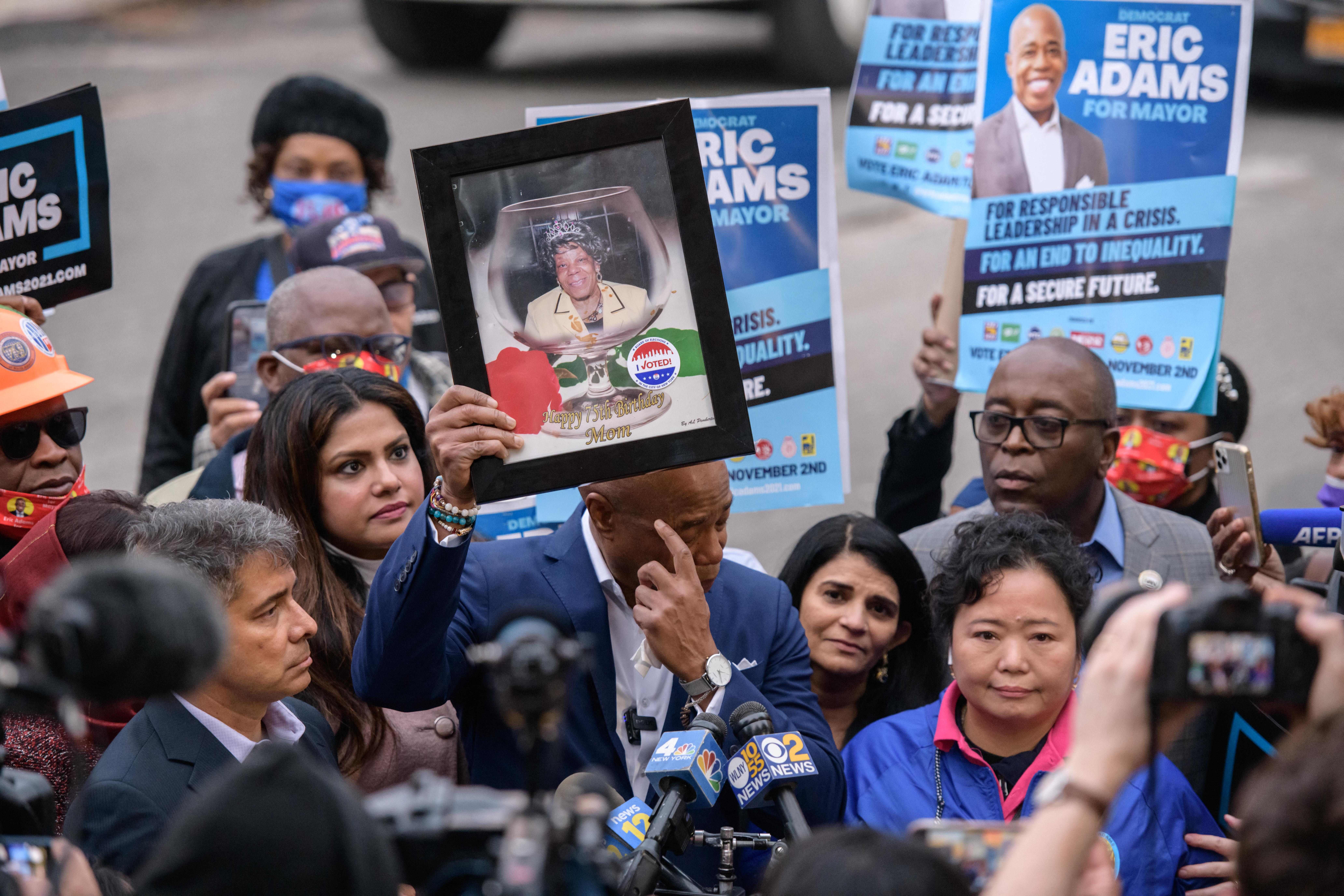 New York democratic mayoral candidate Eric Adams holds a portrait of his late mother Dorothy Mae Adams as he speaks to the media and supporters upon leaving a voting center after casting his ballot in Brooklyn, New York, on Tuesday. 